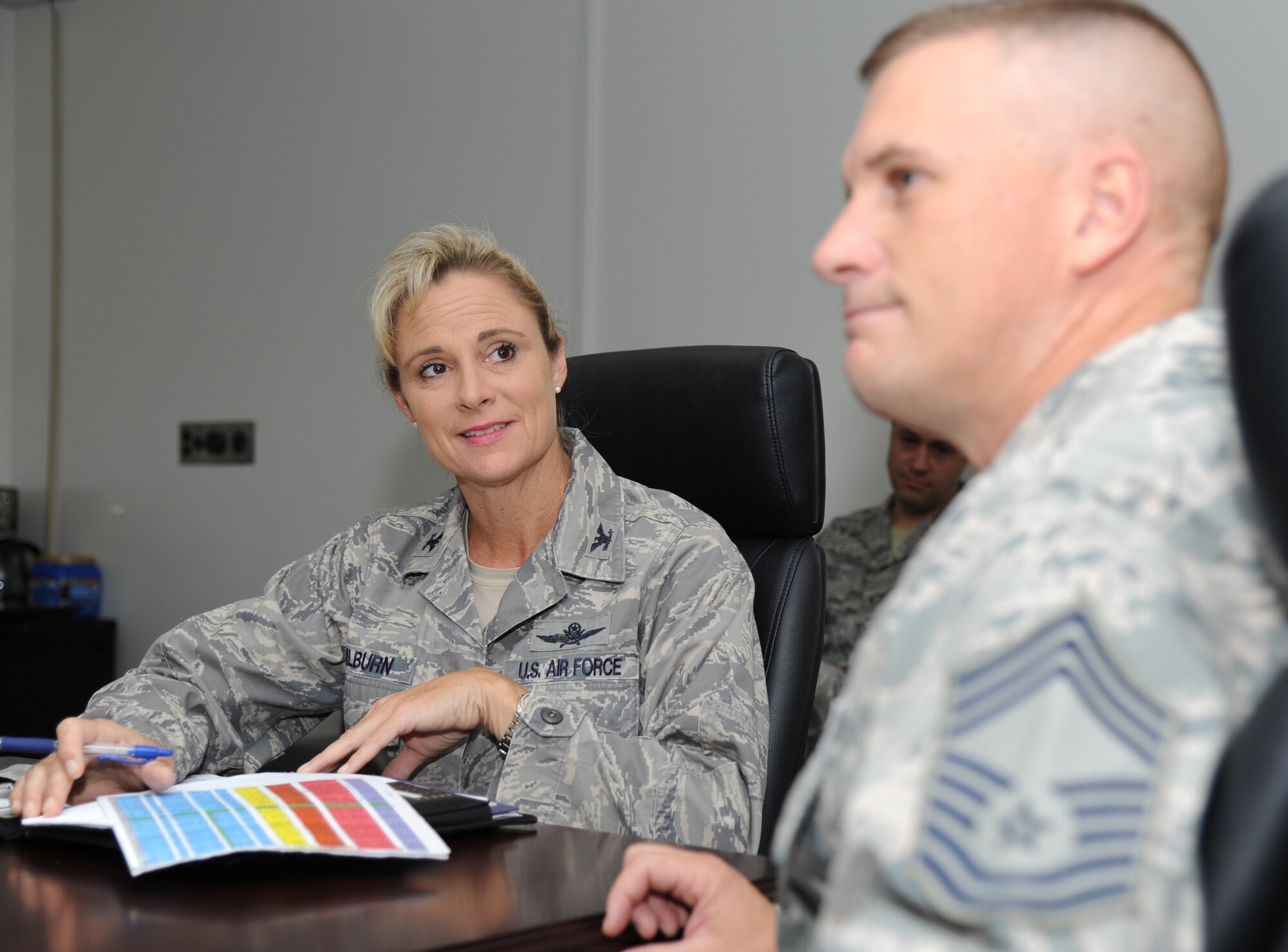 Col. Melanie Milburn, 602nd Training Group (Provisional) commander, receives an update on Joint Expeditionary Tasked Training status from Chief Master Sgt. Tim Servati, 602nd TRG (P) enlisted manager chief, Aug. 21, 2012, at Hewes Hall, Keesler Air Force Base, Miss.  Milburn took command during a ceremony Aug. 2.  (U.S. Air Force photo by Kemberly Groue)