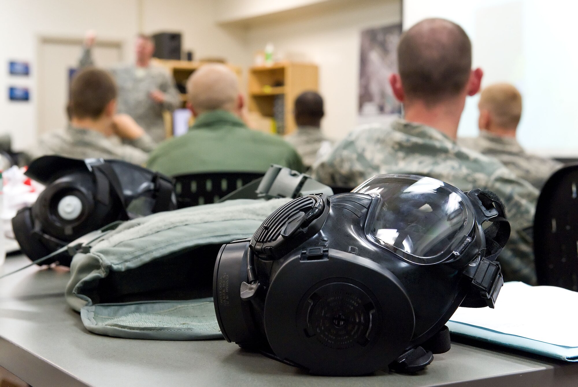 The 436th Civil Engineer Squadron Emergency Management and Training Section teaches service members to don a gas mask in a specified amount of time and drink while wearing the mask. (U.S. Air Force photo by Roland Balik)