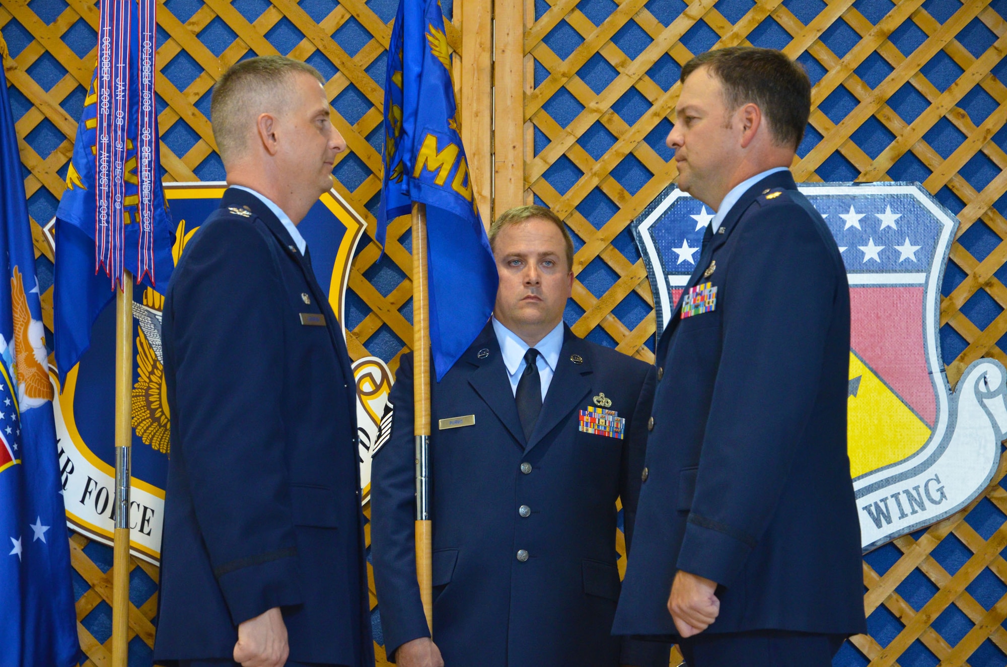 WRIGHT-PATTERSON AIR FORCE BASE, Ohio – Col. Brett Newman, 445th Maintenance Group commander, stands with Maj. Todd Reeder, 445th Maintenance Operations Squadron commander, and Master Sgt. Steven Purvis, MOS first sergeant, as they prepare for the presentation of the new guidon for the redesignated MOS during a ceremony marking the event Aug. 4. (U.S. Air Force photo/Staff Sgt. Robert Nelson)