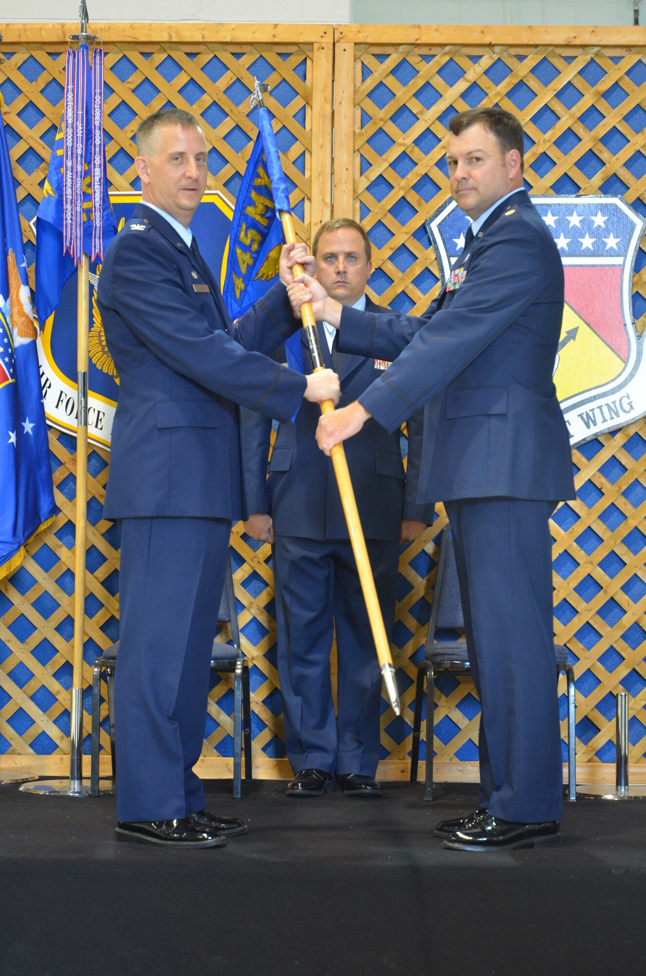 WRIGHT-PATTERSON AIR FORCE BASE, Ohio – Col. Brett Newman, 445th Maintenance Group commander, passes the guidon to Maj. Todd Reeder, 445th Maintenance Operations Squadron commander, during the MOS redesignation ceremony Aug. 4. (U.S. Air Force photo/Staff Sgt. Robert Nelson)
