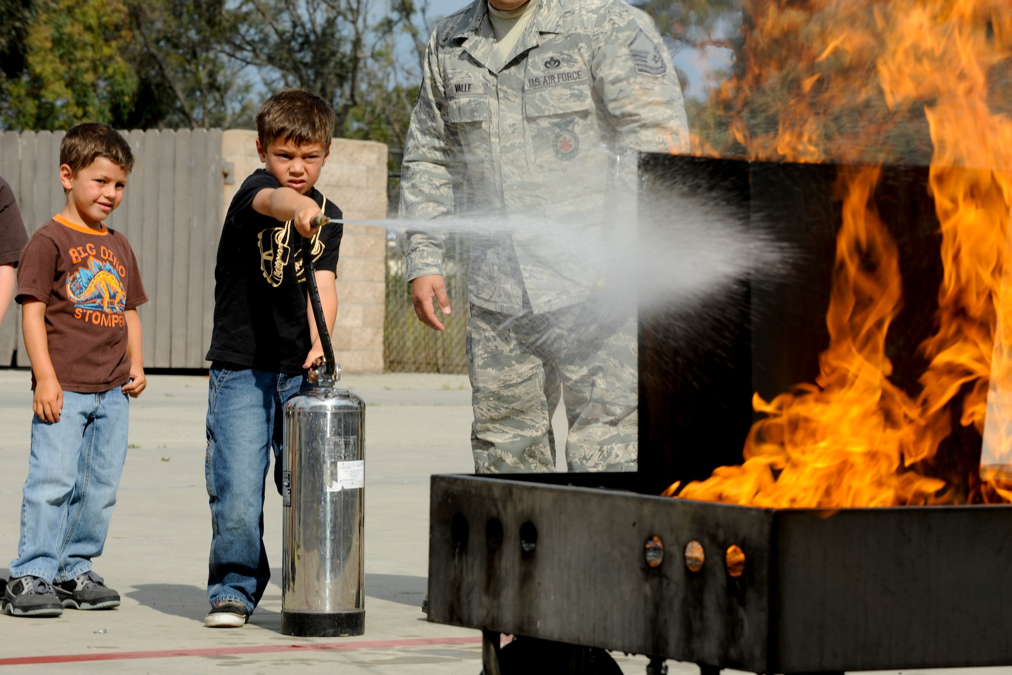 VANDENBERG AIR FORCE BASE, Calif. -- Wyatt Koleff, son of Shannon and Bill Wyatt, Lompoc residents, puts out a fire with a fire extinguisher during the 2012 Kids Fire Camp at Fire Station 2 here Saturday, August 18, 2012. The fire camp was held to provide kids on base with fire safety information, hands-on learning and critical home fire safety skills. (U.S. Air Force photo/Staff Sgt. Levi Riendeau)