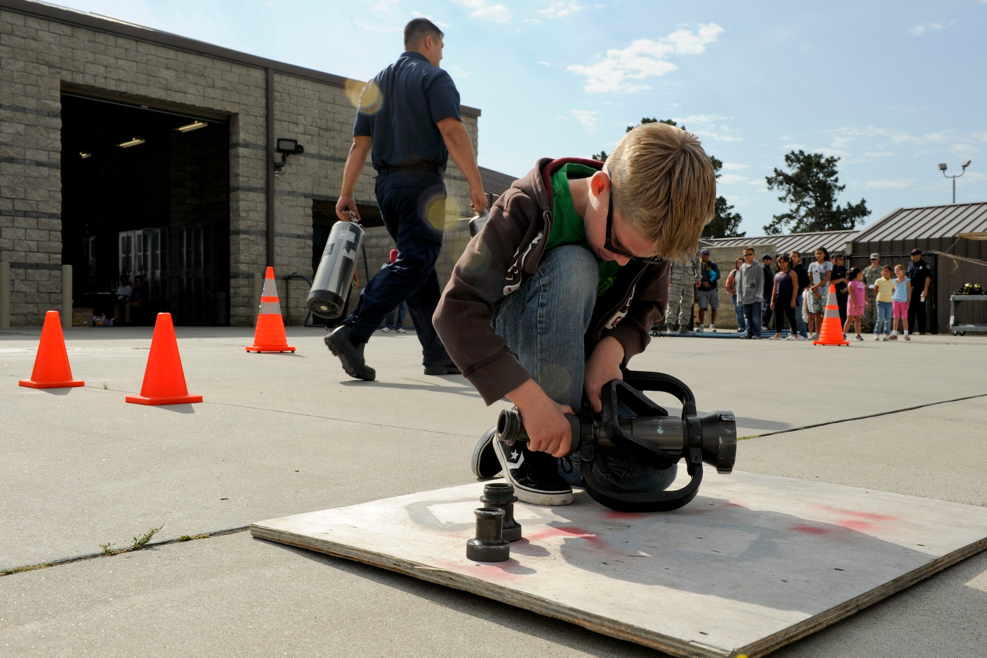 VANDENBERG AIR FORCE BASE, Calif. -- Aiden Pentel, son of Daine and Capt. Johnathan Pentel, a 30th Medical Support Squadron member, assembles a fire hose nozzle while running an obstacle course during the 2012 Kids Fire Camp at Fire Station 2 here Saturday, August 18, 2012. The fire camp was held to provide kids on base with fire safety information, hands-on learning and critical home fire safety skills. (U.S. Air Force photo/Staff Sgt. Levi Riendeau)