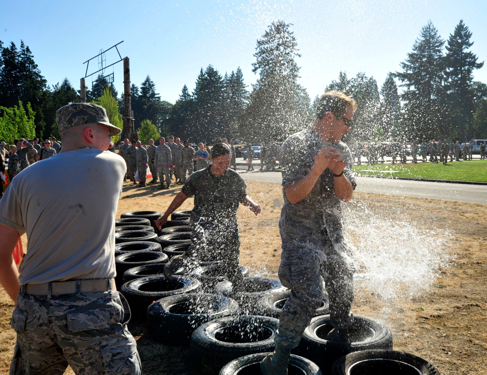 A McChord Field Airman fires a water balloon at another Airman as he passes through the obstacle course, Aug. 17, 2012 during the McChord Field Combat Dining-in at Heritage Hill, Joint Base Lewis-McChord, Wash. As temperatures reached well into the high 80s, the water obstacle course provided a cool reprieve from the heat. (U.S. Air Force photo/Master Sgt. Todd Wivell)