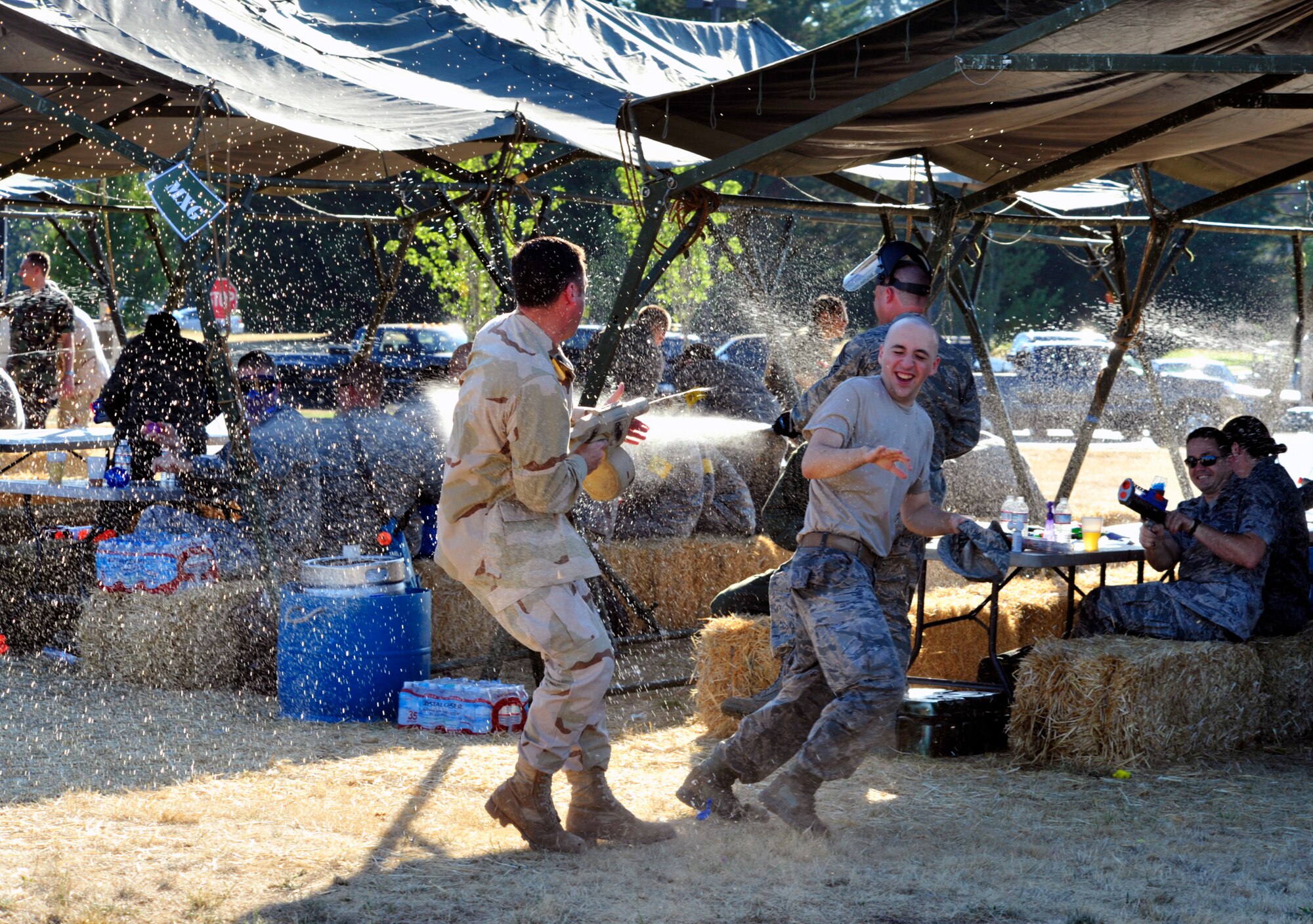 Lt. Col. Robert Farkas (left), 62nd Aerial Port Squadron commander, fires his water gun at an Airman during a simulated attack Aug. 17, 2012, at the McChord Field Combat Dining-in at Heritage Hill, Joint Base Lewis-McChord, Wash. Farkas served as mister vice for this years event. (U.S. Air Force photo/Master Sgt. Todd Wivell)