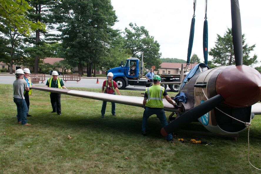 HANSCOM AIR FORCE BASE, Mass. – Workers remove the wings from the P-40 Aug. 1 in order to make transportation to the motor pool easier. (U.S. Air Force photo by Rick Berry)