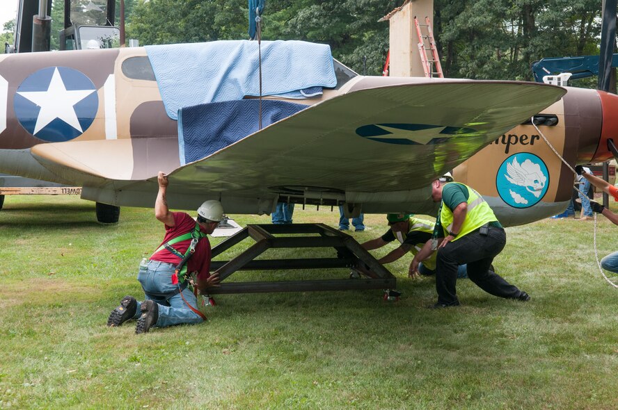 HANSCOM AIR FORCE BASE, Mass. – The P-40 is lowered on to a cradle after being removed from a pedestal Aug. 1. (U.S. Air Force photo by Rick Berry)
