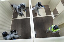 A team of 50th Security Forces Squadron Airmen clears the room during an active-shooter response live scenario training Aug. 20 at the shoot house. The Airmen learned how to enter a facility, how to communicate, move together as a team, reaching the threat and safety throughout the environment. (U.S. Air Force photo/Staff Sgt. Julius Delos Reyes)
