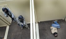 Personnel with the 50th Security Forces Squadron neutralize the threat during an active-shooter response live scenario training Aug. 20 at the shoot house. The Airmen learned how to enter a facility, how to communicate, move together as a team, reach the threat and safety throughout the environment. (U.S. Air Force photo/Staff Sgt. Julius Delos Reyes)