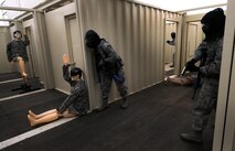 A team of 50th Security Forces Squadron Airmen clears the hallway during an active-shooter response live scenario training Aug. 20 at the shoot house. As part of the training, four security forces personnel respond to a threat, enter the facility, eliminate the threat and clear the building. (U.S. Air Force photo/Staff Sgt. Julius Delos Reyes)