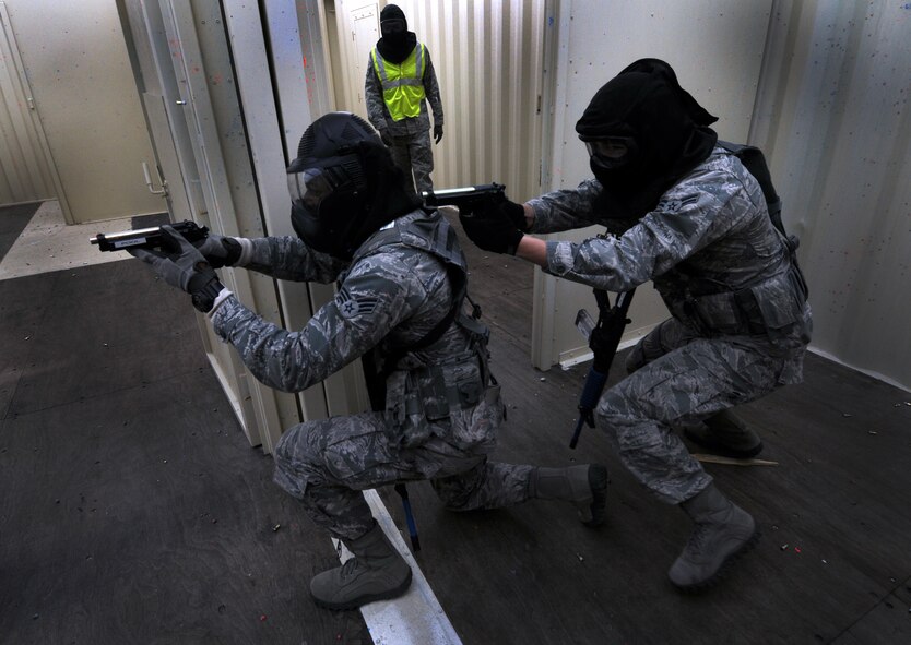 Airmen with the 50th Security Forces Squadron engage with the threat during an active-shooter response live scenario training Aug. 20 at the shoot house. The Airmen learned how to enter a facility, how to communicate, move together as a team, reaching the threat and safety throughout the environment. (U.S. Air Force photo/Staff Sgt. Julius Delos Reyes)