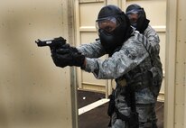 Personnel with the 50th Security Forces Squadron respond to a threat during an active-shooter live scenario training Aug. 20 as part of its annual training program, which includes approximately 20 hours of combined training via classroom, practical applications and live scenarios. Adding realism to the scenarios were the actors playing victims and simulating threats as well as the use of simunitions, a paintball-type weapon. (U.S. Air Force photo/Staff Sgt. Julius Delos Reyes)