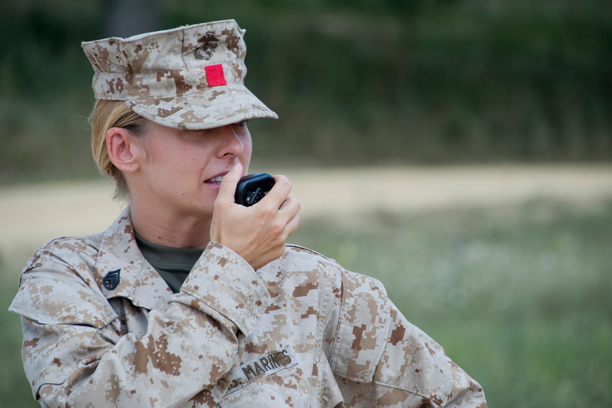 KENSINGTON, Ohio -- U.S. Marine Corps Reserve Staff Sgt. Shirley I. Palotai, camp commandant for Operation Mudslinger and a career retention specialist at 4th Landing Support Battalion based at Youngstown Air Reserve Station, Ohio, communicates with command staff about the progress of a contruction project Aug. 15, 2012 at Seven Ranges Scout Camp here. Airmen, Marines and Sailors from YARS participated in a two-week joint training exercise at the camp and worked together to improve roads and drainage systems, erect campsites and excavate land for future projects. U.S. Air Force photo by Staff Sgt. Megan Tomkins/Released