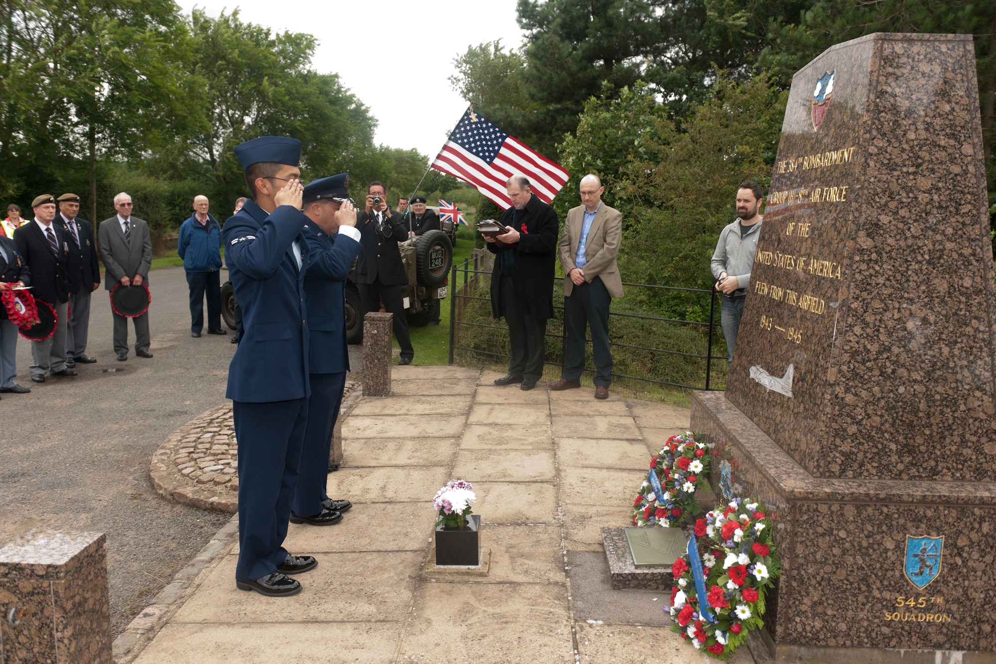 GRAFTON UNDERWOOD, United Kingdom – Col. Brian Kelly, 501st Combat Support wing commander, and Airman 1st Class Brandon Gogue, 423rd Communication Squadron, pay their respects to Eighth Air Force Airmen at the memorial near Grafton Underwood Aug. 17. The day marked the 70th anniversary of the first Eighth Air Force bombers, from the 97th Bombardment Group (Heavy), participating in World War II which launched from Grafton Underwood. Col. Frank Armstrong, 97th BG commander, and the 340th Bomb Squadron commander Maj. Paul Tibbets (who later flew the Enola Gay to Hiroshima, Japan, on the first atomic bomb mission) piloted the lead aircraft of the group, Butcher Shop. In the leading aircraft of the second flight, Yankee Doodle, flew Gen. Ira C. Eaker, the commanding general of the VIII Bomber Command. (U.S. Air Force photo by Staff Sgt. Brian Stives)