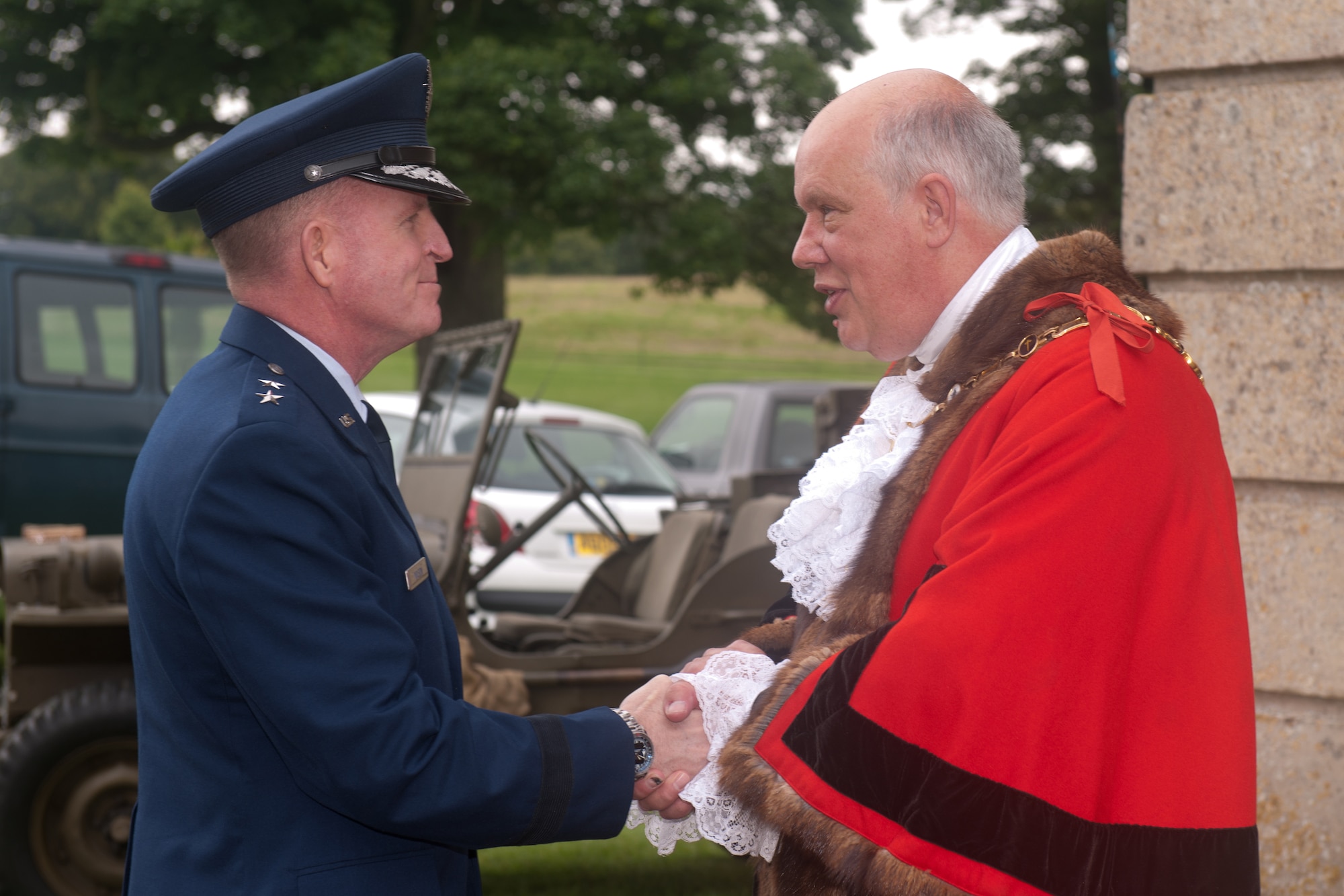 GRAFTON UNDERWOOD, United Kingdom – Councilor James Hakewill, the Mayor of Kettering Borough, greets Maj. Gen. Stephen Wilson, Eighth Air Force commander, as he enters Boughton House Aug. 17. The day marked the 70th anniversary of the first Eighth Air Force bombers, from the 97th Bombardment Group (Heavy), participating in World War II which launched from Grafton Underwood. Col. Frank Armstrong, 97th BG commander, and the 340th Bomb Squadron commander Maj. Paul Tibbets (who later flew the Enola Gay to Hiroshima, Japan, on the first atomic bomb mission) piloted the lead aircraft of the group, Butcher Shop. In the leading aircraft of the second flight, Yankee Doodle, flew Gen. Ira C. Eaker, the commanding general of the VIII Bomber Command. (U.S. Air Force photo by Staff Sgt. Brian Stives)