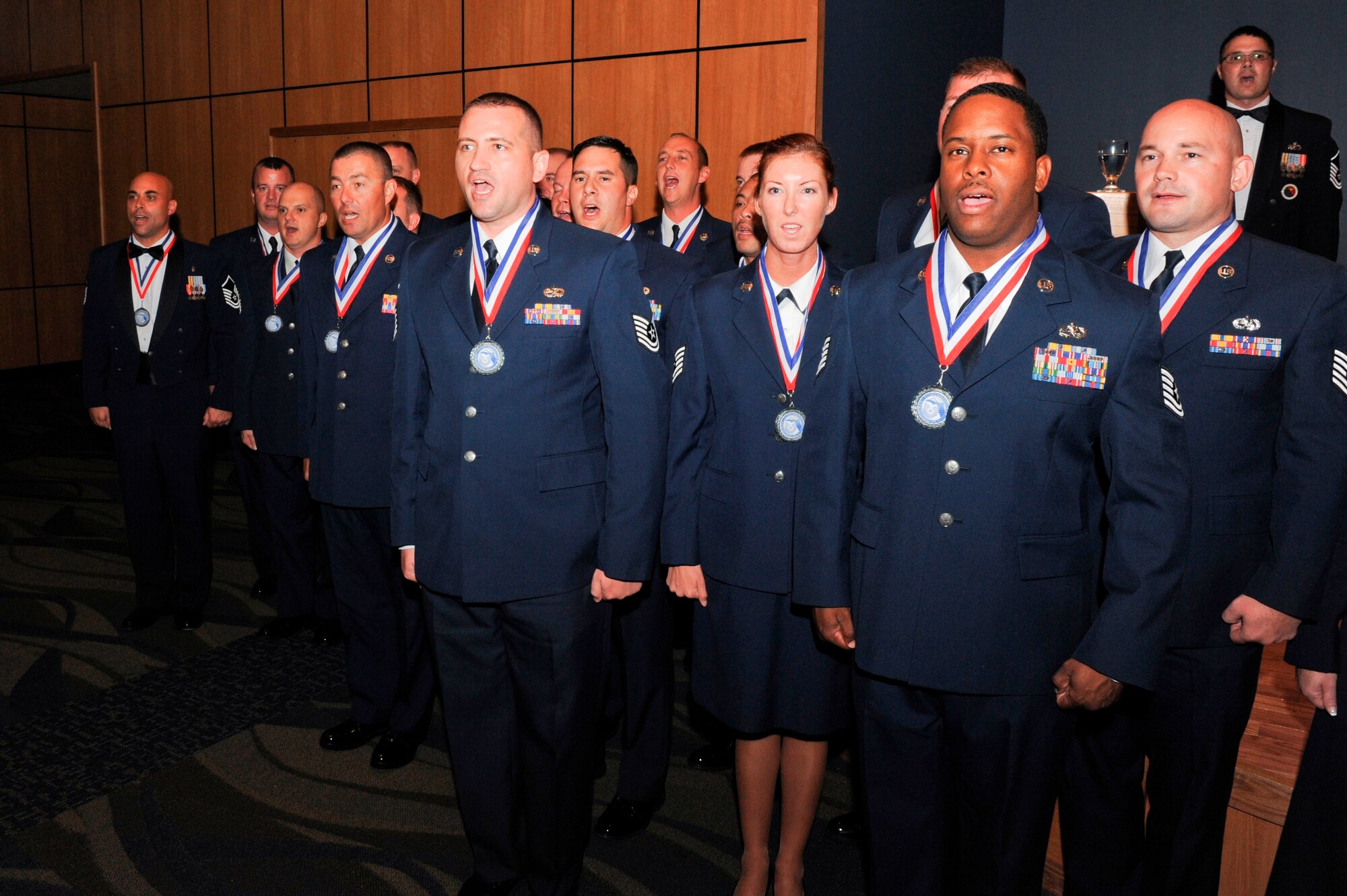 Senior NCO inductees sing the Air Force song Aug. 17 at the Horizons Community Center during the annual Senior NCO Induction Ceremony. (U.S. Air Force photo by Chris Cokeing)