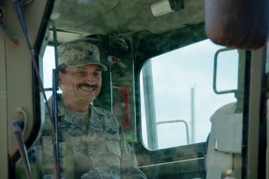 KENSINGTON, Ohio -- U.S. Air Force Reserve Col. Reinhard Schmidt, commander of the 910th Airlift Wing based at Youngstown Air Reserve Station, Ohio, sits inside of a U.S. Marine Corps Reserve heavy equipment machine Aug. 15, 2012 at Seven Ranges Scout Camp here. Airmen, Marines and Sailors from YARS participated in a two-week joint training exercise at the camp and worked together to improve roads and drainage systems, erect campsites and excavate land for future projects. U.S. Air Force photo by Staff Sgt. Megan Tomkins/Released