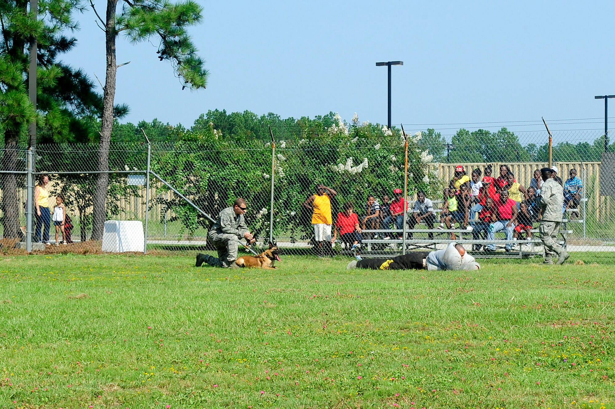Members of the 20th Security Forces Squadron K-9 unit demonstrate a search using a canine for the Crosswell Improvement Group at Shaw Air Force Base, S.C., Aug. 17, 2012. The group toured multiple areas of the base and viewed how Shaw accomplishes its mission. (U.S. Air Force photo by Airman 1st class Hunter Brady/Released)