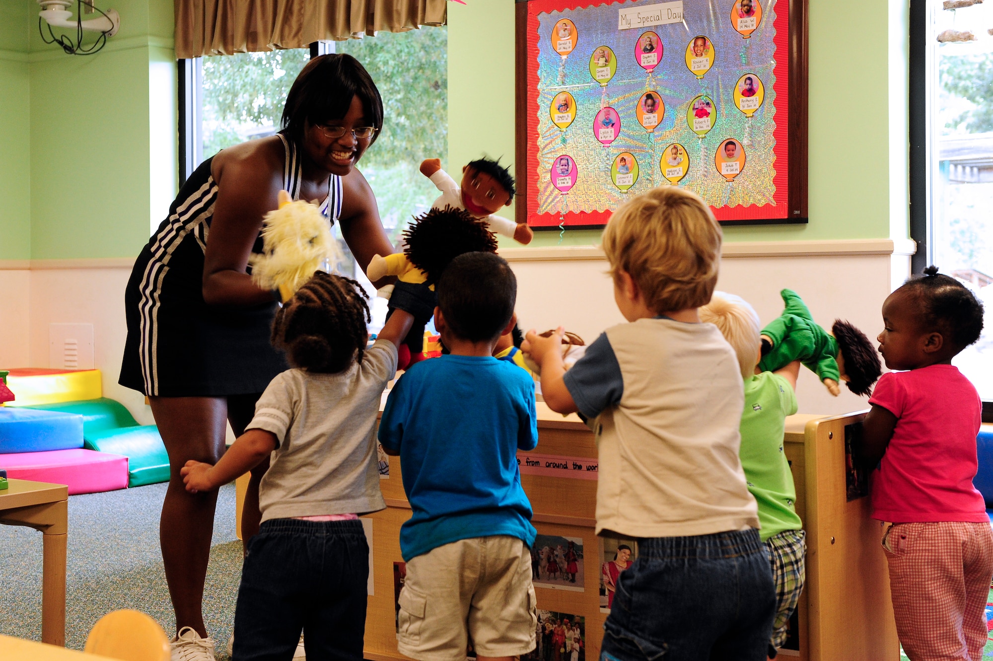 Crestwood High school varsity cheerleading captian MicKayla Ketter plays with toddler class 5-B at Shaw Air Force Base, S.C., Aug. 15, 2012. Ketter and members of her high school’s cheer squad came to teach children about sportsmanship and teamwork. (U.S. Air Force photo by Airman 1st Class Hunter Brady /Released)