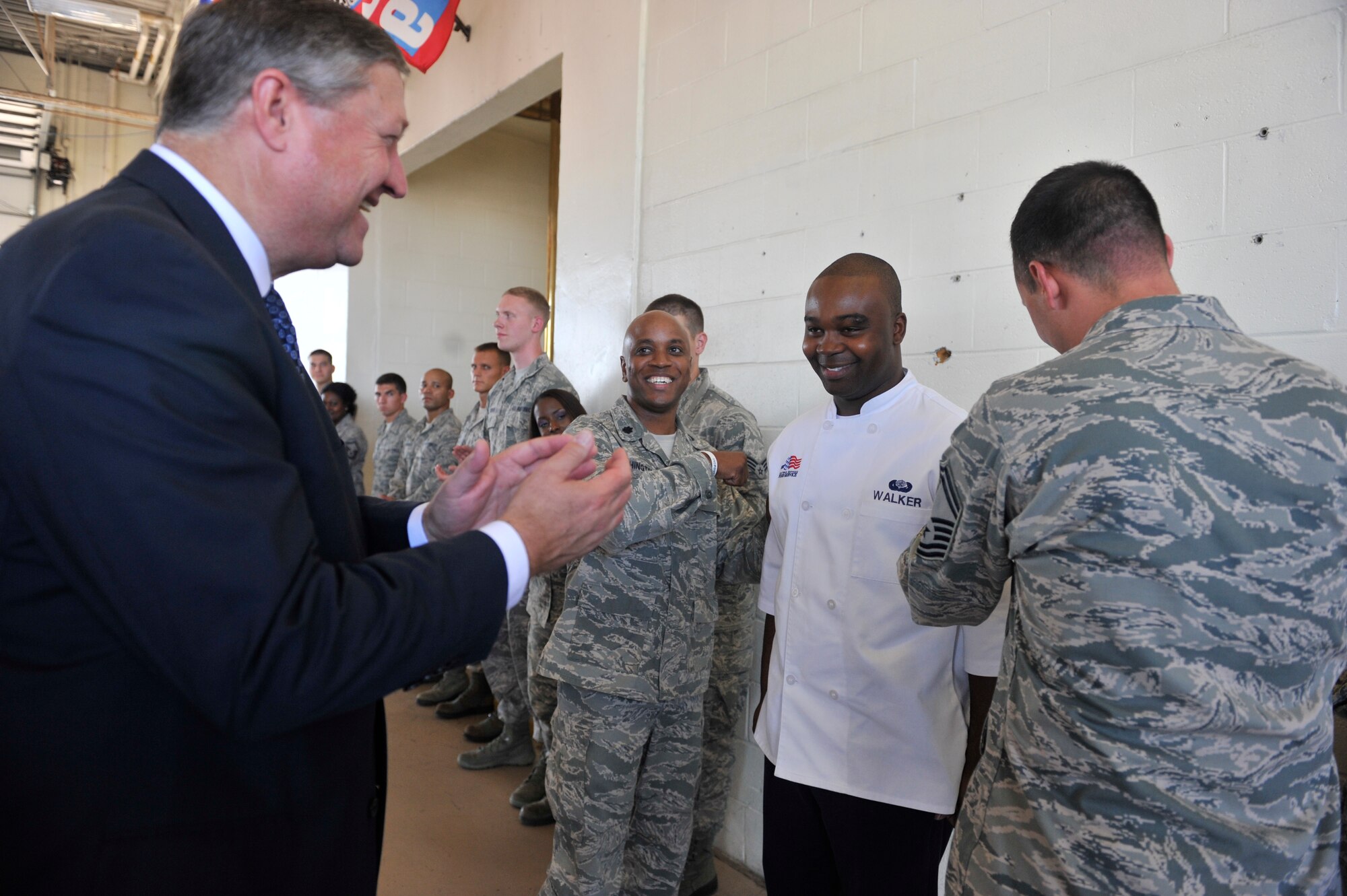 Secretary of the Air Force Michael Donley applauds as Airman 1st Class Wendell Walker is awarded Senior Airman below the zone, Aug. 16, 2012, Shaw Air Force Base, S.C. Walker achieved the rank of Senior Airman six month early for excellence in his career and service to the community. Donley presented a coin to Walker in congratulations. (U.S. Air Force photo by Staff Sgt. Ave Young)
