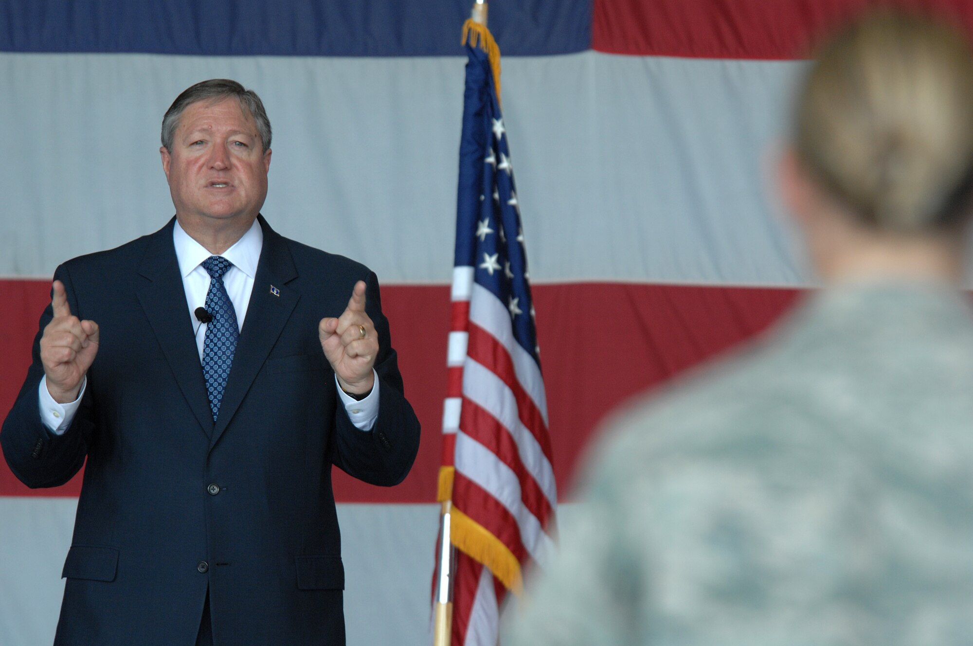 Secretary of the Air Force Michael Donley addresses a question asked by an Airman during an all call, held inside hangar 1200 at Shaw Air Force Base, S.C., Aug. 16, 2012. During the assembly Donley spoke about changes of the Air Force for Fiscal Year 2013, such as budgeting and modernization. (U.S. Air Force photo by Staff Sgt. Ave Young/Released)
