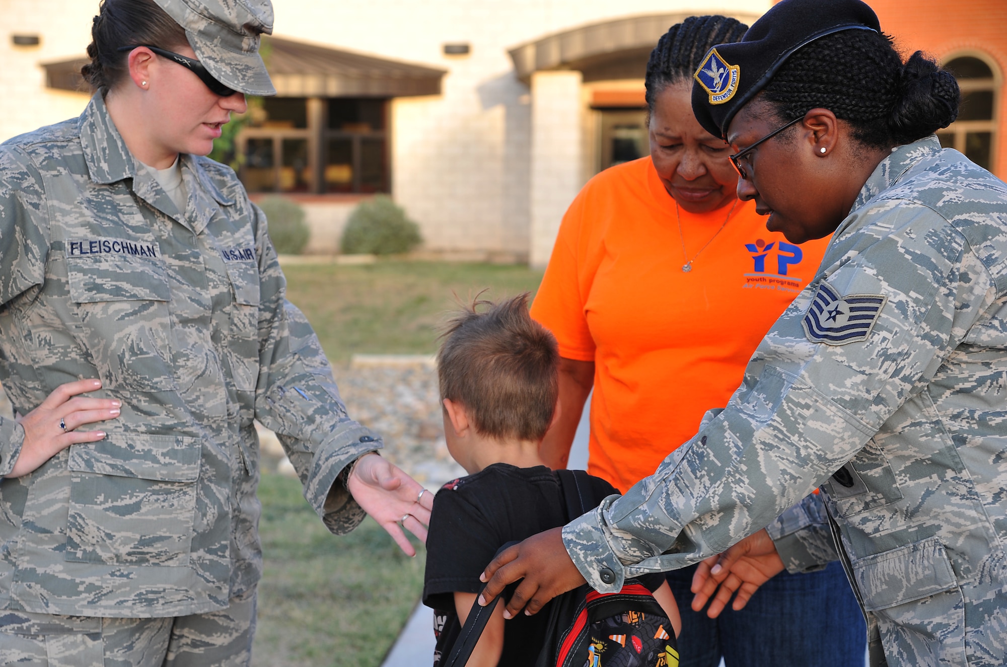 GOODFELLOW AIR FORCE BASE, Texas-- Tech. Sgt Sabrina Lukas helps Reuben Fleischman, son of Staff Sgt. Jennifer Fleischman, 17th Force Support Squadron, try on a backpack at the School Age Program building Aug. 17. The 17th SFS raised money to donate backpacks and school supplies to children before the start of school. (U.S. Air Force photo/ Airman 1st Class Michael Smith)