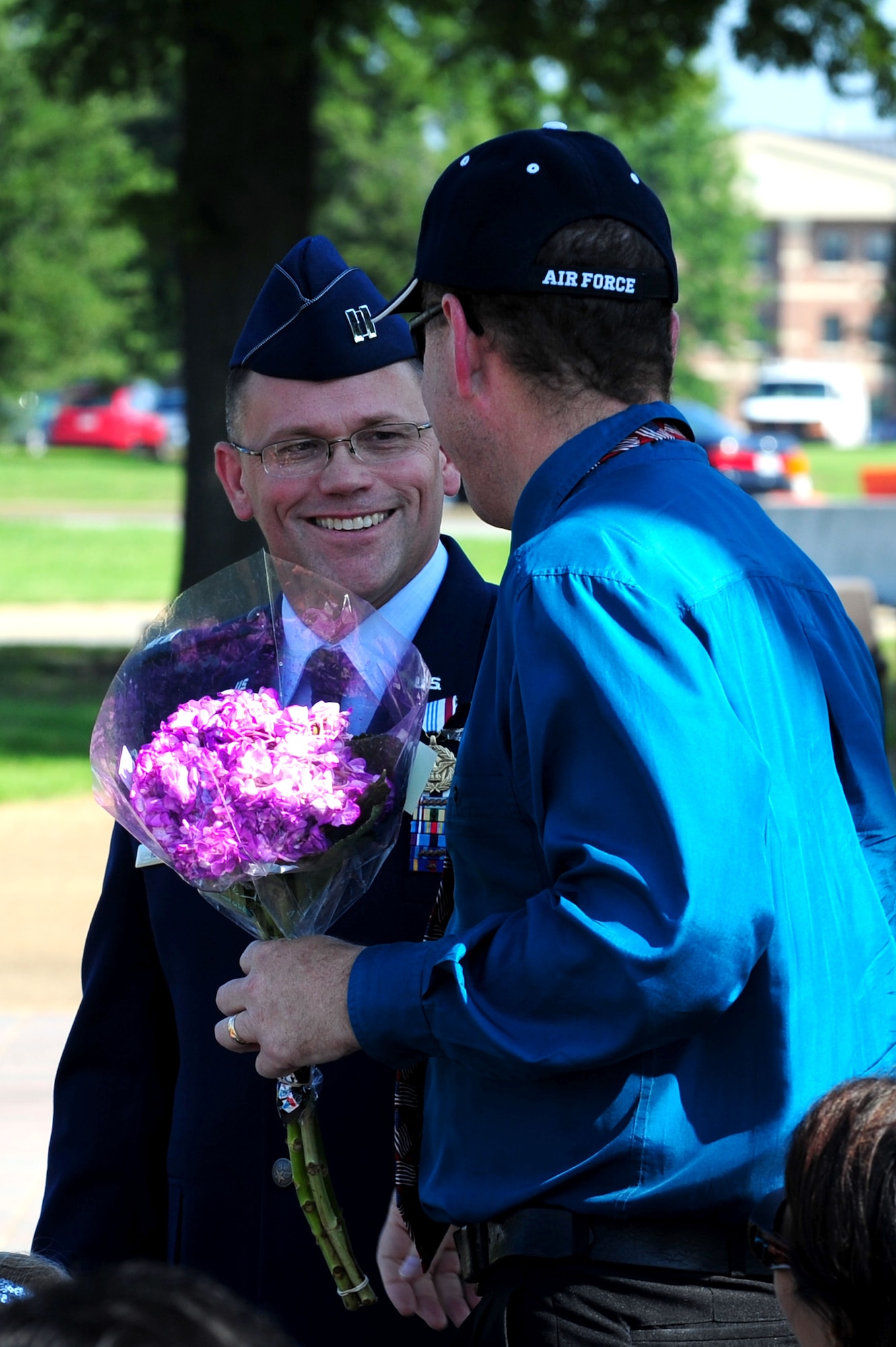 During his retirement ceremony, U.S. Air Force Capt. Patrick Kelly, NATO Communications Information Services Agency command staff group commander, greets Dean Dark, a survivor of the 1990 Honduras terrorist attack, at Langley Air Force Base, Va., Aug. 17, 2012. Kelly and Dark are among eight Airmen wounded in Honduras during a terrorist attack in 1990.  (U.S. Air Force photo by Airman 1st Class Kayla Newman/Released)