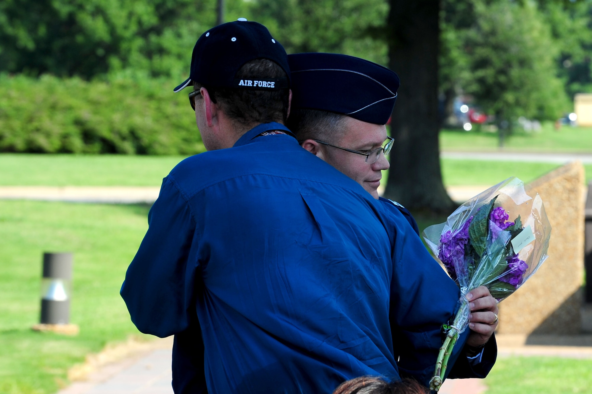 During his retirement ceremony, U.S. Air Force Capt. Patrick Kelly, NATO Communications Information Services Agency command staff group commander, embraces Dean Dark, a fellow survivor of the 1990 Honduras terrorist attack, at Langley Air Force Base, Va., Aug. 17, 2012.  Kelly and Dark were deployed together in 1990, when their van came under attack from three snipers in Honduras.  (U.S. Air Force photo by Airman 1st Class Kayla Newman/Released)