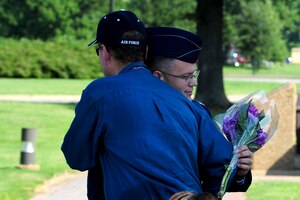 During his retirement ceremony, U.S. Air Force Capt. Patrick Kelly, NATO Communications Information Services Agency command staff group commander, embraces Dean Dark, a fellow survivor of the 1990 Honduras terrorist attack, at Langley Air Force Base, Va., Aug. 17, 2012.  Kelly and Dark were deployed together in 1990, when their van came under attack from three snipers in Honduras.  (U.S. Air Force photo by Airman 1st Class Kayla Newman/Released)