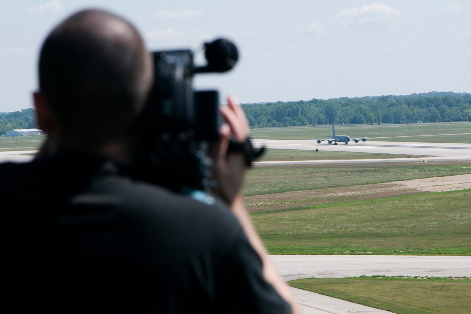 GRISSOM AIR RESERVE BASE, Ind. -- Derrick Ellis, an intern with WFYI Productions, films a KC-135R Stratotanker from the air traffic control tower here as it prepares for takeoff Aug. 1. Indiana media outlets converged on Grissom to experience an aerial refueling flight and learn about the base. (U.S. Air Force photo/Senior Airman Andrew McLaughlin)
