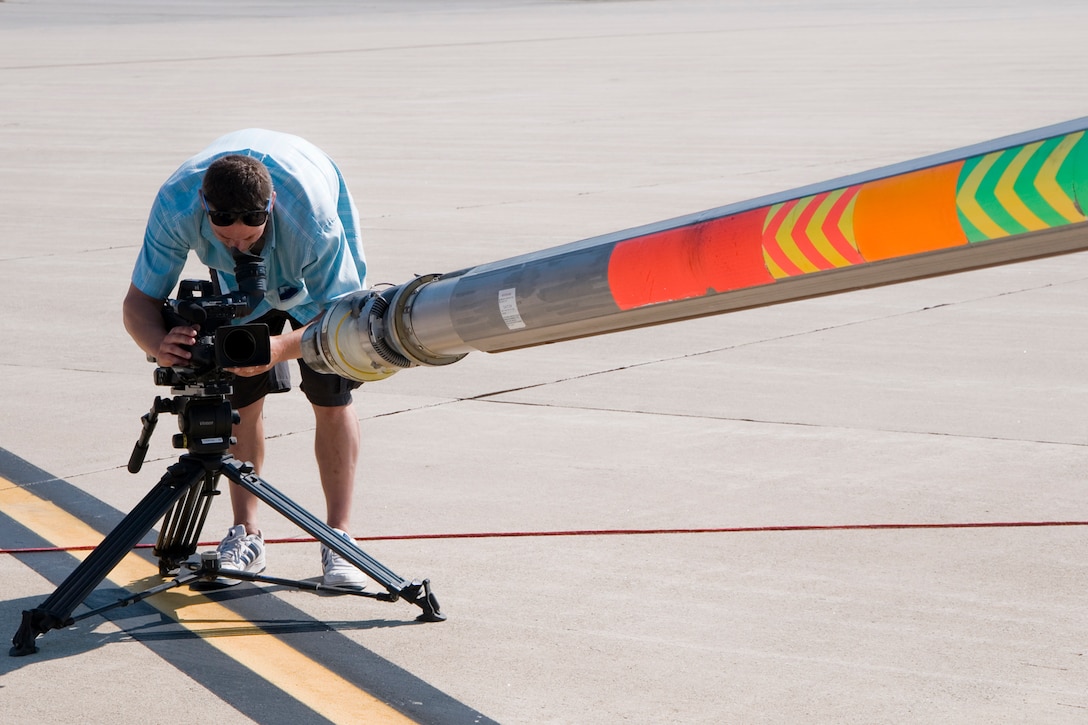 GRISSOM AIR RESERVE BASE, Ind. -- Chris Elberfeld, director of videography for WFYI Productions, films a boom extended from a KC-135R Stratotanker while it was undergoing maintenance here Aug. 1. Elberfeld was part of a crew that was capturing footage for a documentary about aviation in Indiana. (U.S. Air Force photo/Senior Airman Andrew McLaughlin)
