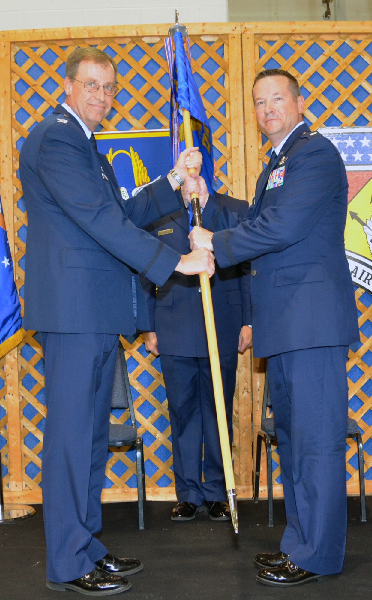 WRIGHT-PATTERSON AIR FORCE BASE, Ohio – Col. Stephen Goeman, 445th Airlift Wing commander, passes the guidon to Col. Kenneth Council, Jr., incoming 445th Operations Group commander, during the 445th OG Change of Command ceremony Aug. 4. (U.S. Air Force photo/Staff Sgt. Amanda Duncan)