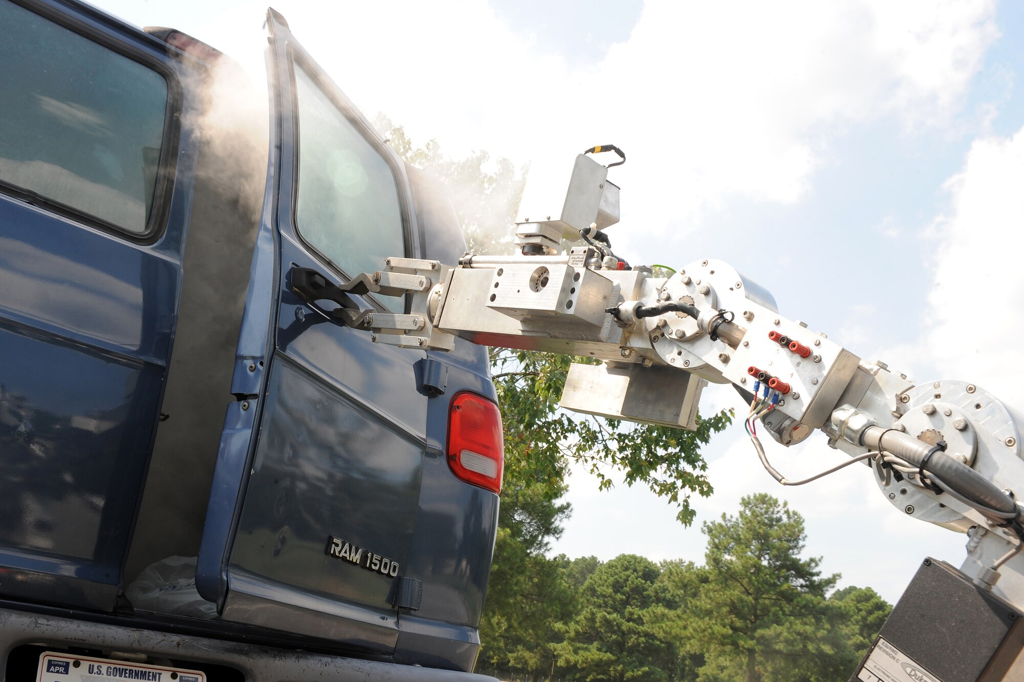 An F6-A explosive ordnance disposal robot opens the back door of a van filled with simulated chemical agents during an exercise on Seymour Johnson Air Force Base, N.C., Aug. 14, 2012. The F6-A is used to examine areas or suspicious objects when sending in human personnel is too dangerous. (U.S. Air Force photo/Airman 1st Class John Nieves Camacho/Released)
