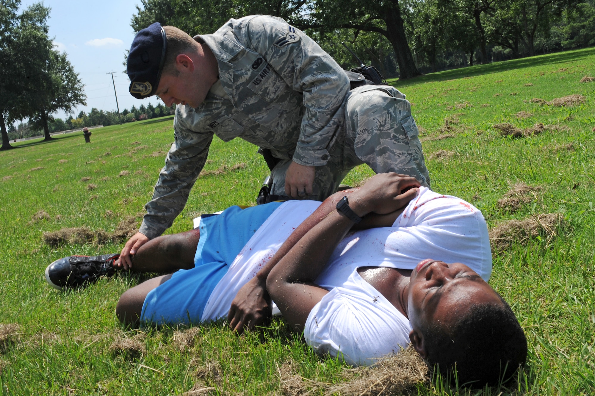 U.S. Air Force Airman 1st Class Brandon Sheets, 4th Security Forces Squadron force protector, searches a victim after a simulated shootout during an exercise on Seymour Johnson Air Force Base, N.C., Aug. 14, 2012. The exercise tested emergency responders to see how they react to an attack on base. (U.S. Air Force photo/Airman 1st Class John Nieves Camacho/Released)