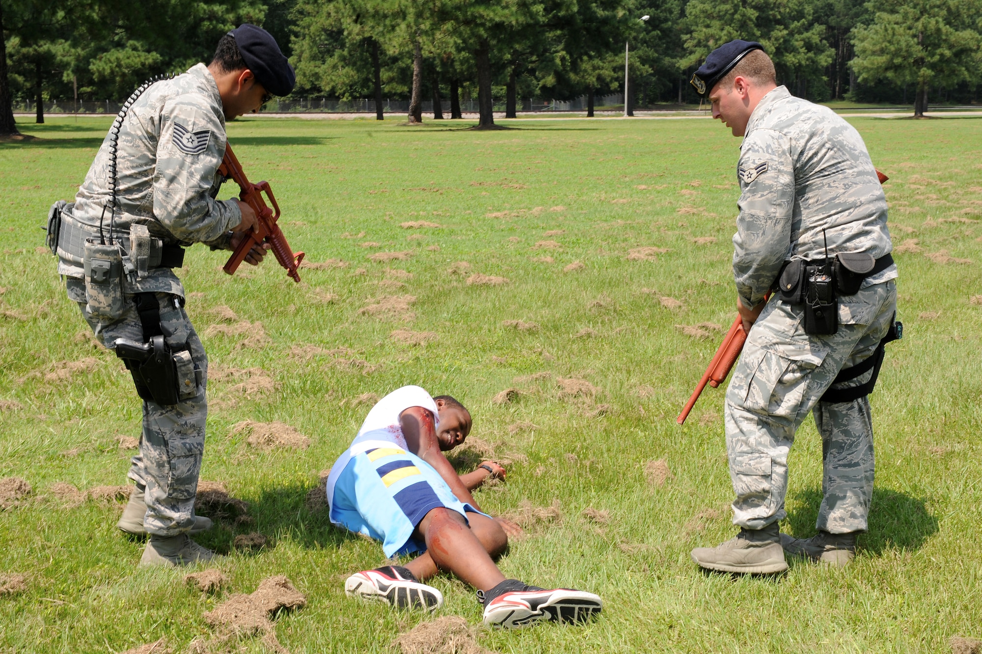 U.S. Air Force Tech. Sgt. Khalil Sewell, 4th Security Forces Squadron flight chief, and Airman 1st Class Brandon Sheets, 4th SFS force protector, apprehend a victim following a simulated shootout during an exercise on Seymour Johnson Air Force Base, N.C., Aug. 14, 2012. This exercise was performed to test various organizations on how they react to an attack. (U.S. Air Force photo/Airman 1st Class John Nieves Camacho/Released)