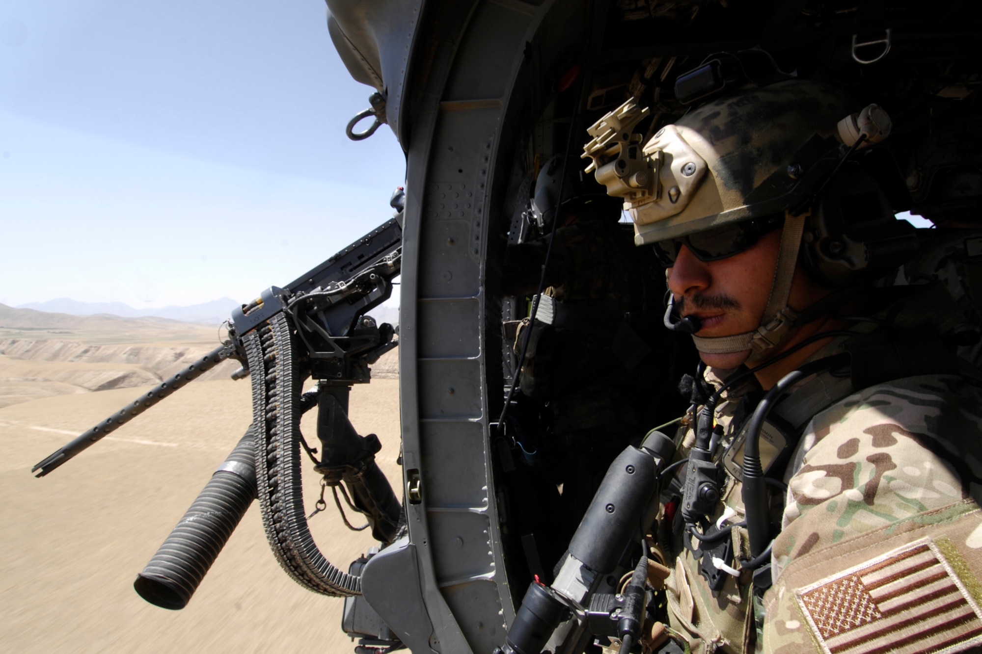 SSgt Steven Nisbet, a pararescue jumper assigned to the 83rd Expeditionary Rescue Squadron peers out the side door of a U.S. Air Force HH-60 Pave Hawk helicopter as the Hindu Kush mountain range comes into view during a training mission at Bagram Airfield, Afghanistan, Aug. 18, 2012. Brig. Gen. Joseph Guastella, 455th Air Expeditionary Wing commander, took part in a nearly two hour training mission with PJ’s and CROs of the 83 ERQS, also known as the “Pedros,” to see firsthand how they contribute to the war on terrorism here in Afghanistan. Guastella expressed his appreciation for their efforts and for their part in continuing to making the mission a success. (U.S. Air Force photo/SSgt Jeff Nevison)