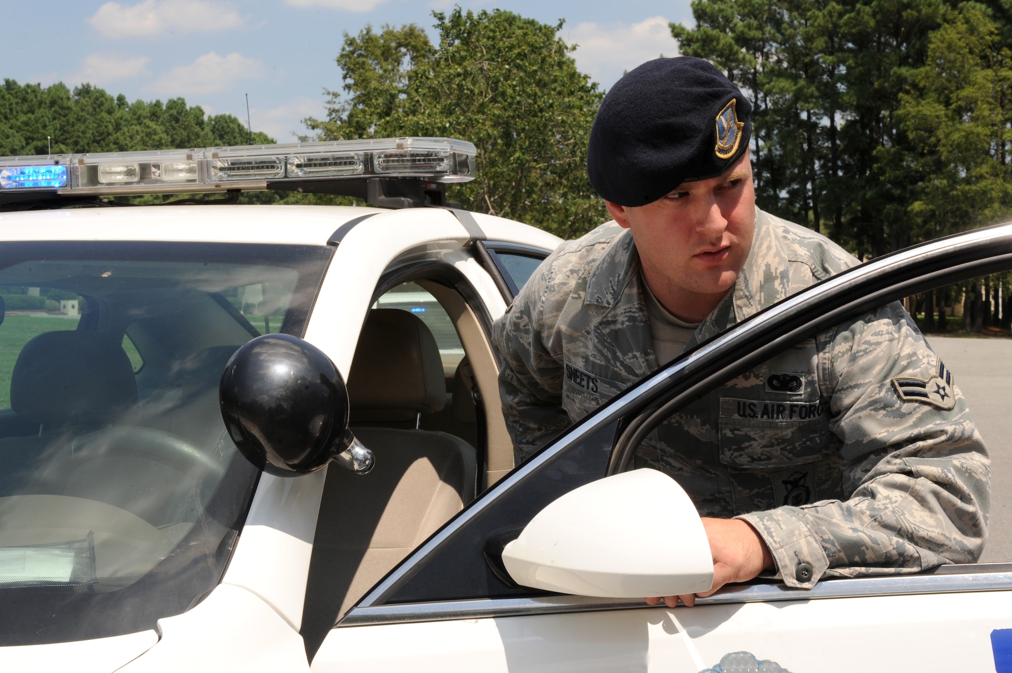 U.S. Air Force Airman 1st Class Brandon Sheets, 4th Security Forces Squadron force protector, scans the surrounding area following a car chase during an exercise on Seymour Johnson Air Force Base, N.C., Aug. 14, 2012. Security forces members clear incident areas of any safety hazards prior to personnel approaching the scene. (U.S. Air Force photo/Airman 1st Class John Nieves Camacho/Released)