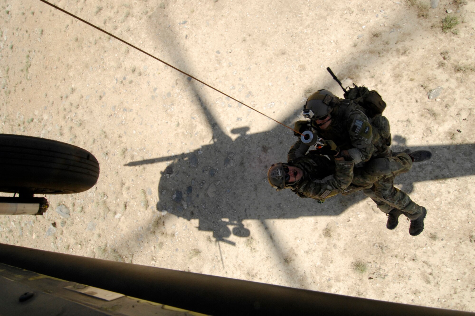 A pararescue jumper and a combat rescue officer from the 83rd Expeditionary Rescue Squadron are hoisted into a U.S. Air Force HH-60 Pave Hawk helicopter during a training mission at Bagram Airfield, Afghanistan, Aug. 18, 2012. Brig. Gen. Joseph Guastella, 455th Air Expeditionary Wing commander, took part in a nearly two hour training mission with PJs and CRO of the 83 ERQS, also known as the “Pedros,” to see firsthand how they contribute to the war on terrorism here in Afghanistan. Guastella expressed his appreciation for their efforts and for their part in continuing to making the mission a success. (U.S. Air Force photo/SSgt Jeff Nevison)