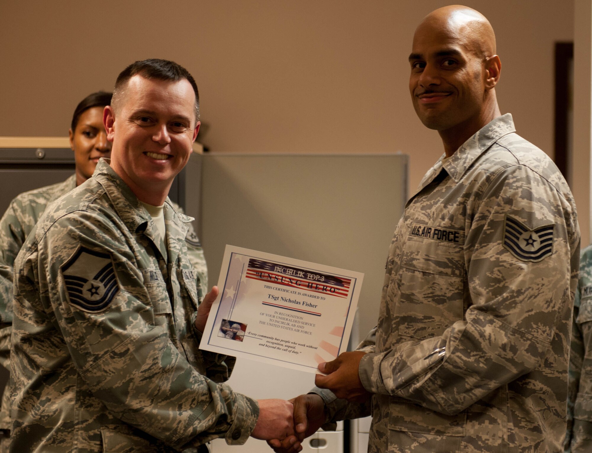 Tech. Sgt. Nicholas Fisher, 39th Contracting Squadron, receives the Unsung Hero Award from the Incirlik Top 3 organization Aug. 21, 2012, at Incirlik Air Base, Turkey. The Top 3 presents the Unsung Hero Award monthly to an Airman who demonstrates superior job performance and exceptional leadership. (U.S. Air Force photo by Senior Airman Anthony Sanchelli/Released)
