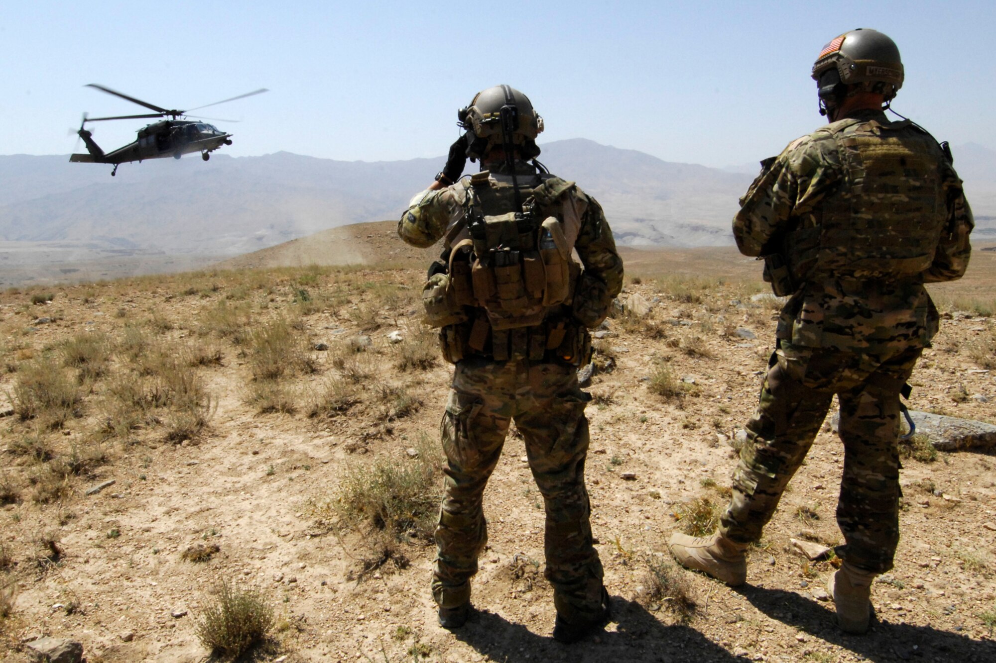 1st Lt Daniel Balch, a combat rescue officer from the 83rd Expeditionary Rescue Squadron, and Brig. Gen. Joseph Guastella, 455th Air Expeditionary Wing commander, wait for a U.S. Air Force HH-60 Pave Hawk to land to simulate a rescue operation during a training mission at Bagram Airfield, Afghanistan, Aug. 18, 2012. During the nearly two hour training mission, Guastella participated with pararescue jumpers and CROs of the 83 ERQS, also known as the “Pedros,” to see firsthand how they contribute to the war on terrorism here in Afghanistan. Guastella expressed his appreciation for their efforts and for their part in continuing to making the mission a success. (U.S. Air Force photo/SSgt Jeff Nevison)