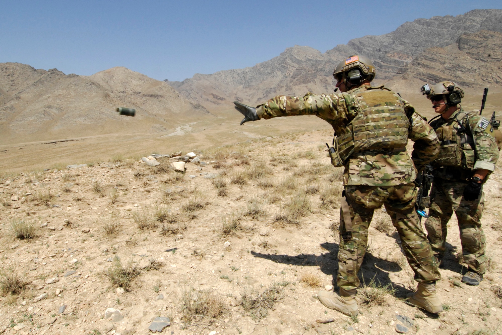 Brig. Gen. Joseph Guastella (front right), 455th Air Expeditionary Wing commander, tosses a smoke grenade to mark a landing zone during a training mission that he took part in with pararescue jumpers and combat rescue officers assigned to the 83rd Expeditionary Rescue Squadron at Bagram Airfield, Afghanistan, Aug. 18, 2012. During the nearly two hour training mission, Guastella participated with PJs and CROs of the 83 ERQS, also known as the “Pedros,” to see firsthand how they contribute to the war on terrorism here in Afghanistan. Guastella expressed his appreciation for their efforts and for their part in continuing to making the mission a success. (U.S. Air Force photo/SSgt Jeff Nevison)