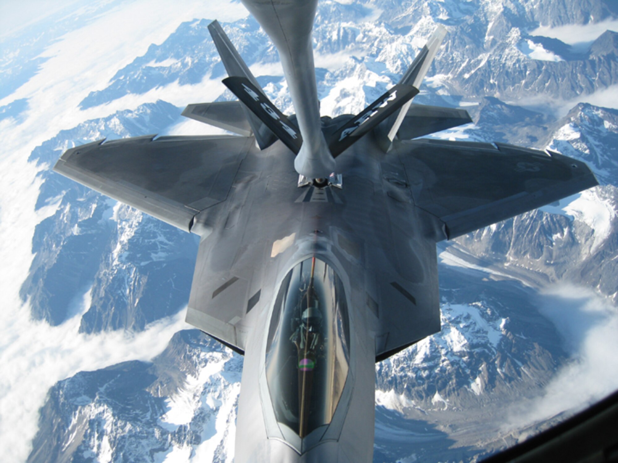 ELMENDORF AIR FORCE BASE, Alaska. -- An F-22 Raptor from the 90th Fighter Squadron is refueld by a KC-135 Stratotanker from the 434th Air Refueling Wing, Grissom Air Reserve Base, Ind. The F-22 is the United States Air Force's newest fighter aircraft and performs both air-to-air and air-to-ground missions. (U.S. Air Force photo/Chief Master Sgt. Jeff Maier) 