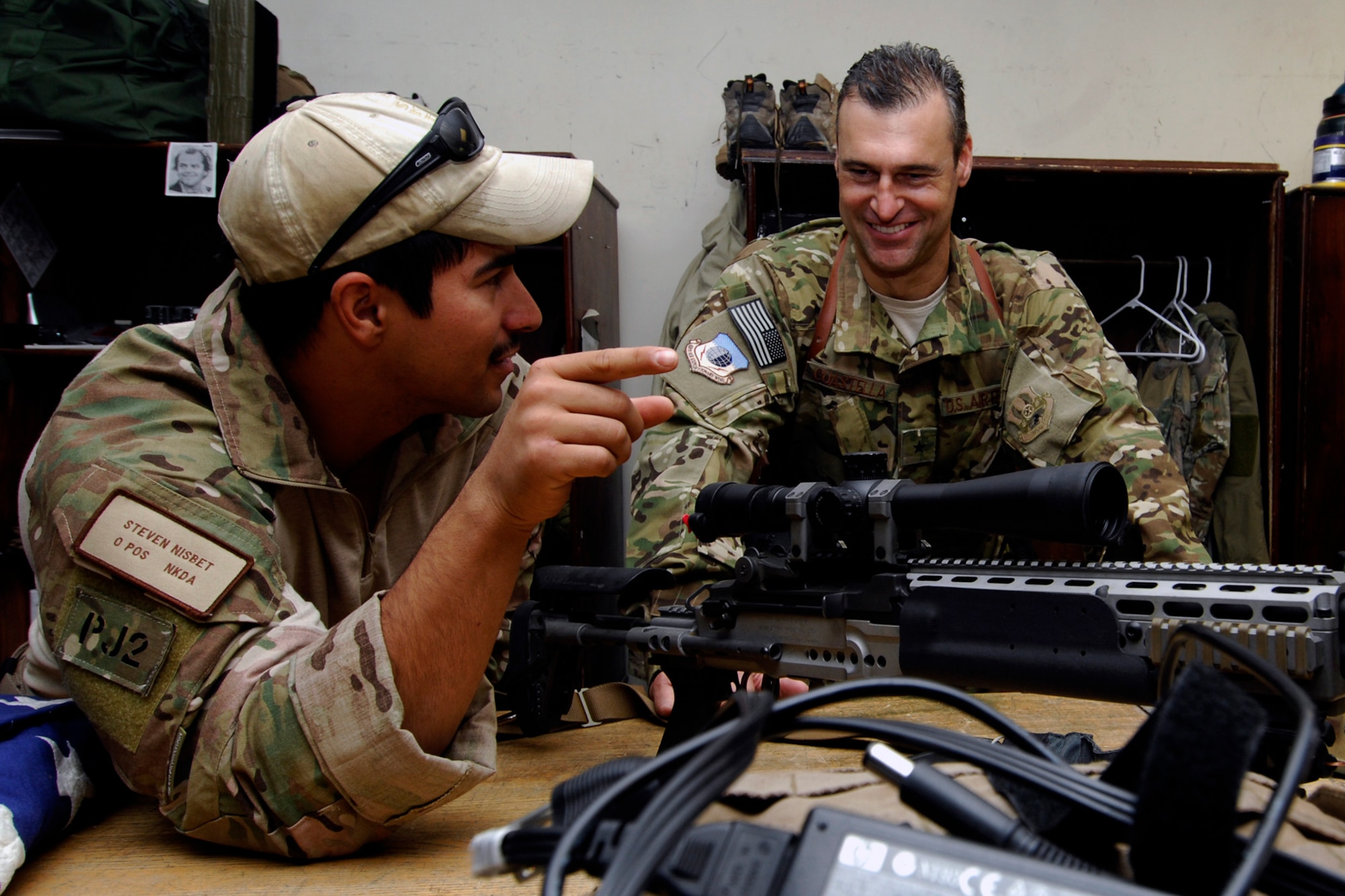 SSgt Steven Nisbet, a pararescue jumper assigned to the 83rd Expeditionary Rescue Squadron at Bagram Air Field Afghanistan, explains the special features of an enhanced battle rifle to Brig. Gen. Joseph Guastella, 455th Air Expeditionary Wing commander, during his visit to the squadron, Aug. 18, 2012. Guastella took part in a nearly two hour training mission with PJs and combat rescue officers of the 83 ERQS, also known as the “Pedros,” to see firsthand how they contribute to the war on terrorism here in Afghanistan. Guastella expressed his appreciation for their efforts and for their part in continuing to making the mission a success. (U.S. Air Force photo/SSgt Jeff Nevison)