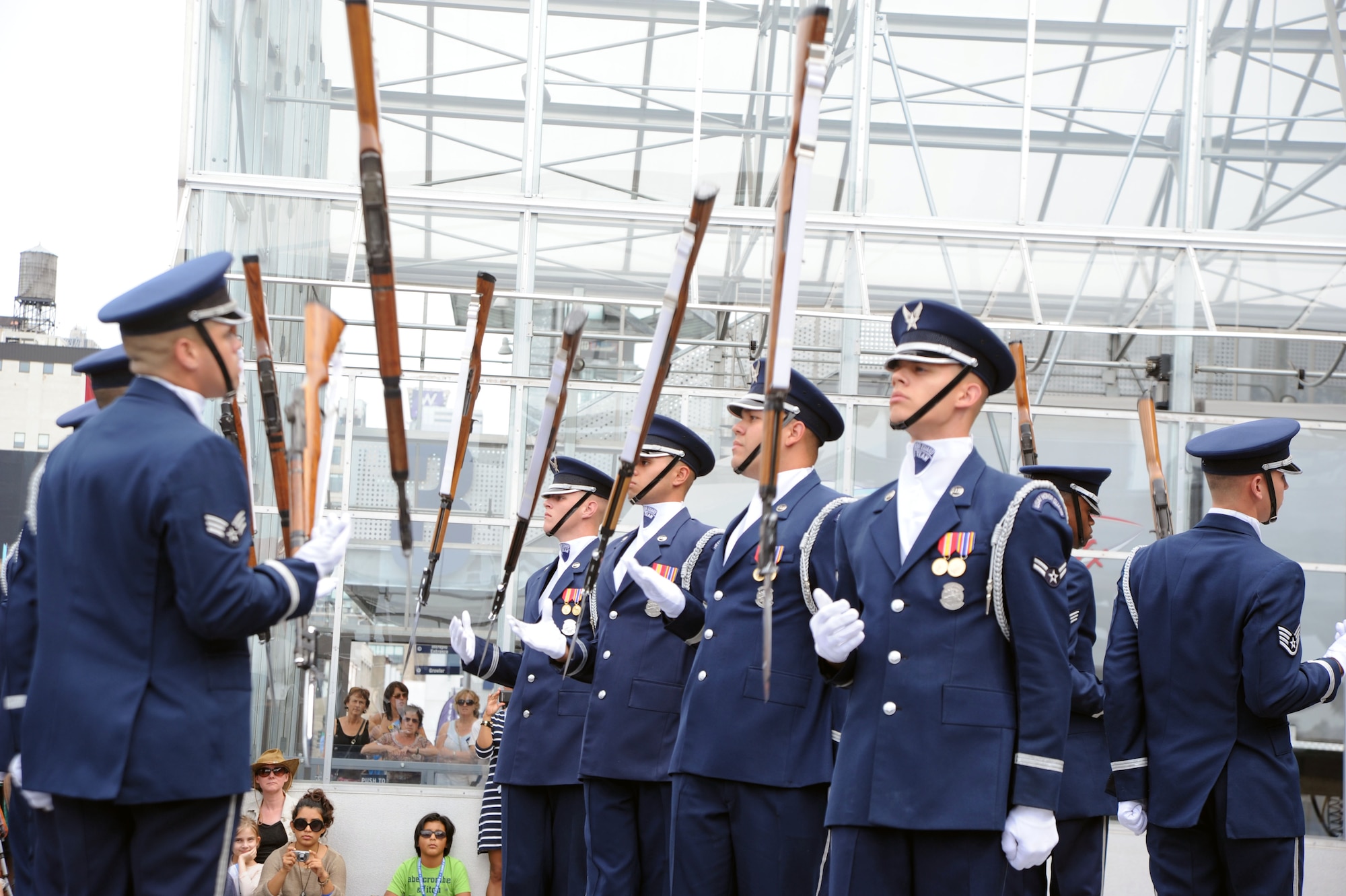 The U.S. Air Force Honor Guard Drill Team throw their M-1 rifles Aug.19 during an Air Force Week perfornace in New York, N.Y. The Drill Team promotes the Air Force mission by showcasing drill performances at public and military venues to recruit, retain, and inspire Airmen. (U.S. Air Force photo by Senior Airman Tabitha N. Haynes) 