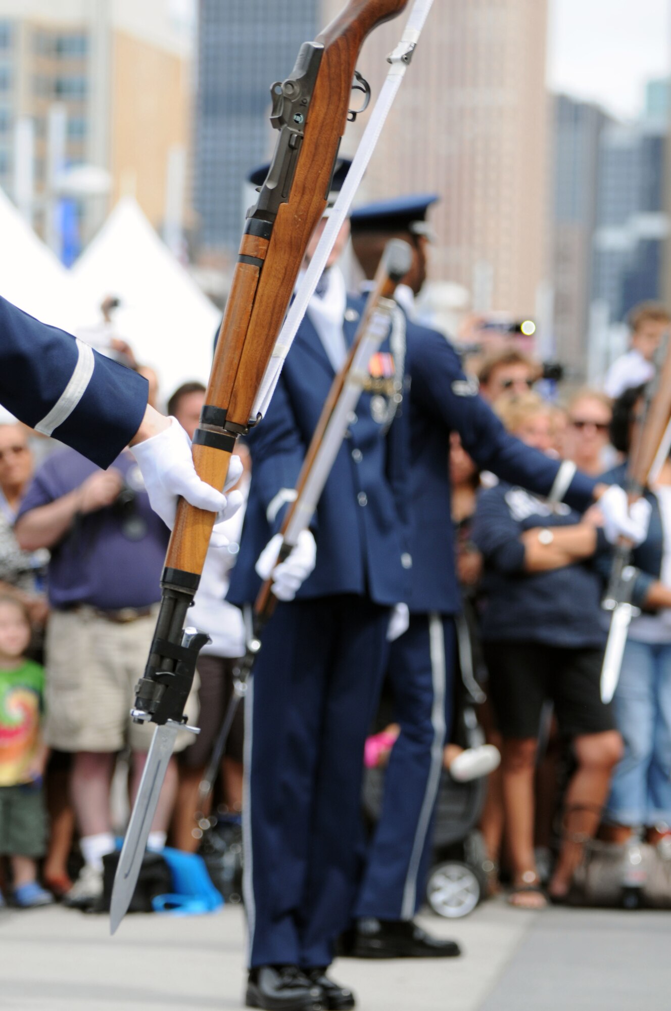 The U.S. Air Force Honor Guard Drill Team hold their M-1 rifles upside down before throwing them in the air Aug. 19 on Pier 86 during Air Force Week in New York, N.Y. The Drill Team promotes the Air Force mission by showcasing drill performances at public and military venues to recruit, retain, and inspire Airmen. (U.S. Air Force photo by Senior Airman Tabitha N. Haynes)