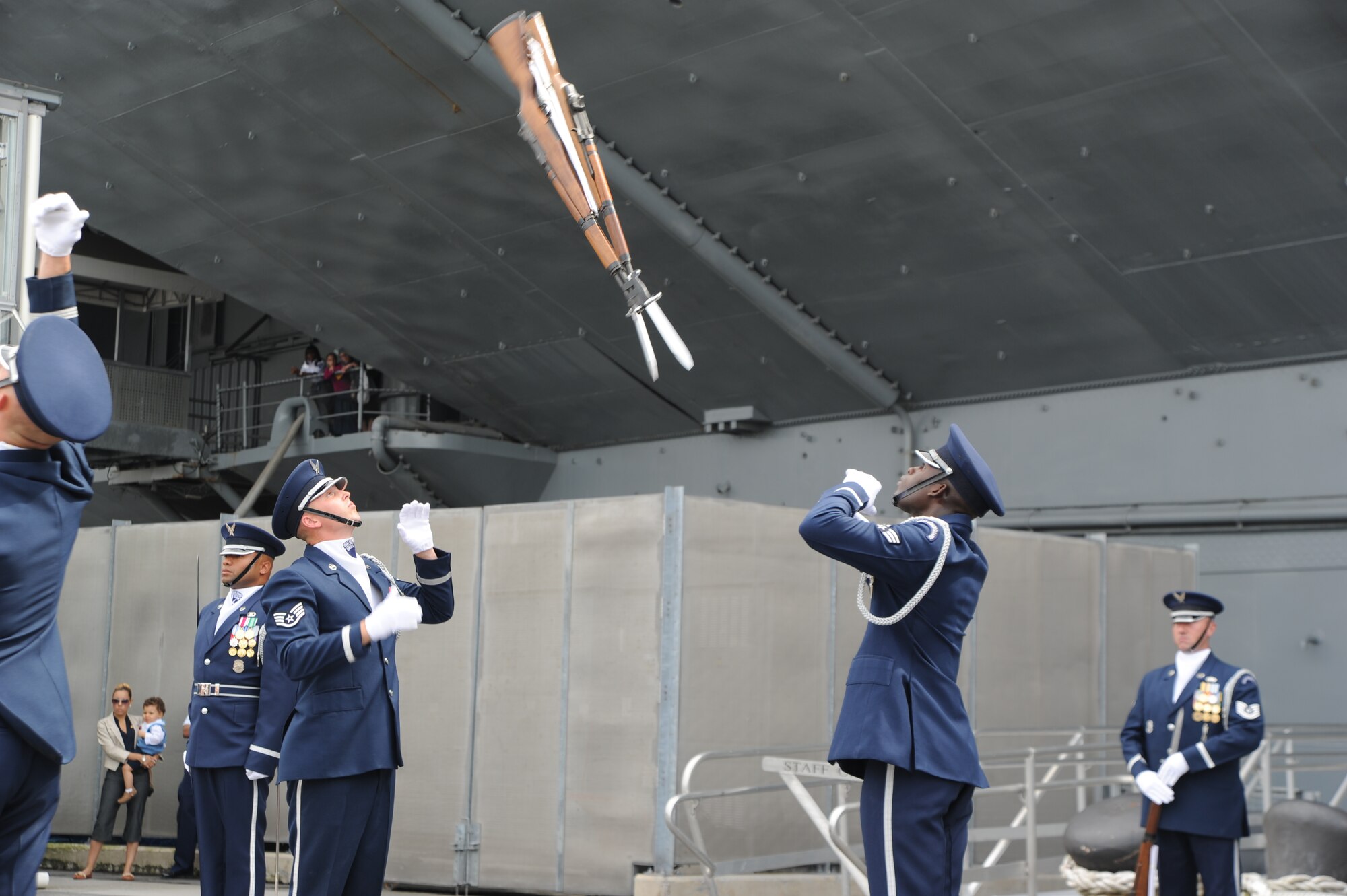 Staff Sgt. Hunter Overton and Senior Airman Billy Degraffenreid, U.S. Air Force Honor Guard Drill Team ceremonial guardsmen, exchange M-1 rifles mid-air Aug. 19 during Air Force Week in New York, N.Y. The Drill Team promotes the Air Force mission by showcasing drill performances at public and military venues to recruit, retain, and inspire Airmen. (U.S. Air Force photo by Senior Airman Tabitha N. Haynes)