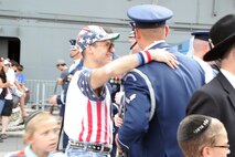 The U.S. Air Force Honor Guard Drill Team ceremonial guardsmen talk with New Yorkers Aug. 19 following their Air Force Week performance on Pier 86, New York, N.Y. The Drill Team promotes the Air Force mission by showcasing drill performances at public and military venues to recruit, retain, and inspire Airmen. (U.S. Air Force photo by Senior Airman Tabitha N. Haynes)