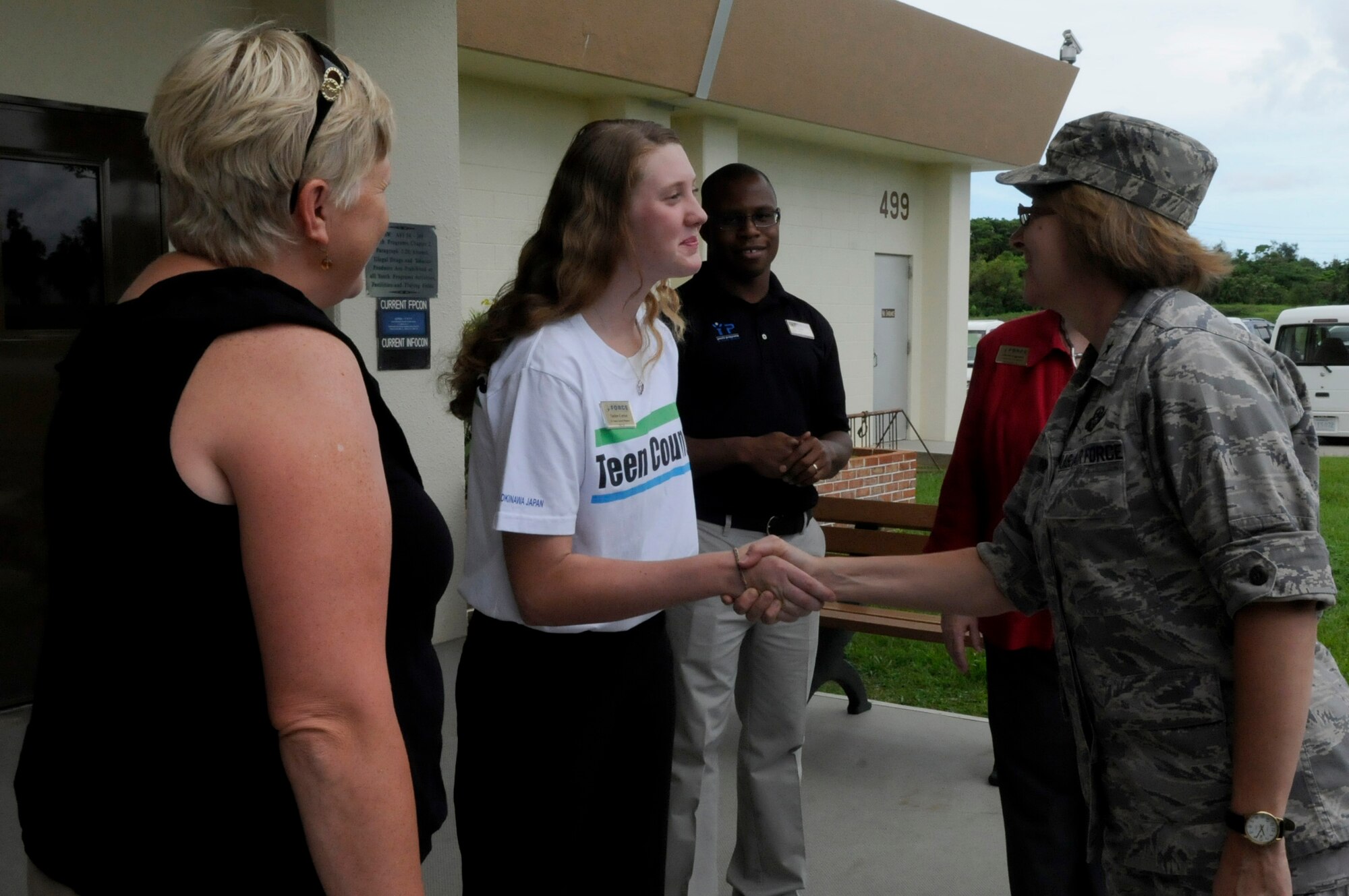Taylor Carter, president of the Kadena Teen Center's Keystone Club, greets U.S. Air Force Brig. Gen. Eden Murrie, Air Force Services director, at the Kadena Teen Center during a tour of the 18th Force Support Squadron facilities on Kadena Air Base, Japan, Aug. 17, 2012. Carter said the Teen Center is doing well to provide a positive environment where kids can be together and engage in activities while watched over by a caring, professional staff. The overall visit for Murrie was to become more familiar with overseas force support services as part of a Pacific Air Forces tour. (U.S. Air Force photo/ Airman 1st Class Tara A. Williamson)