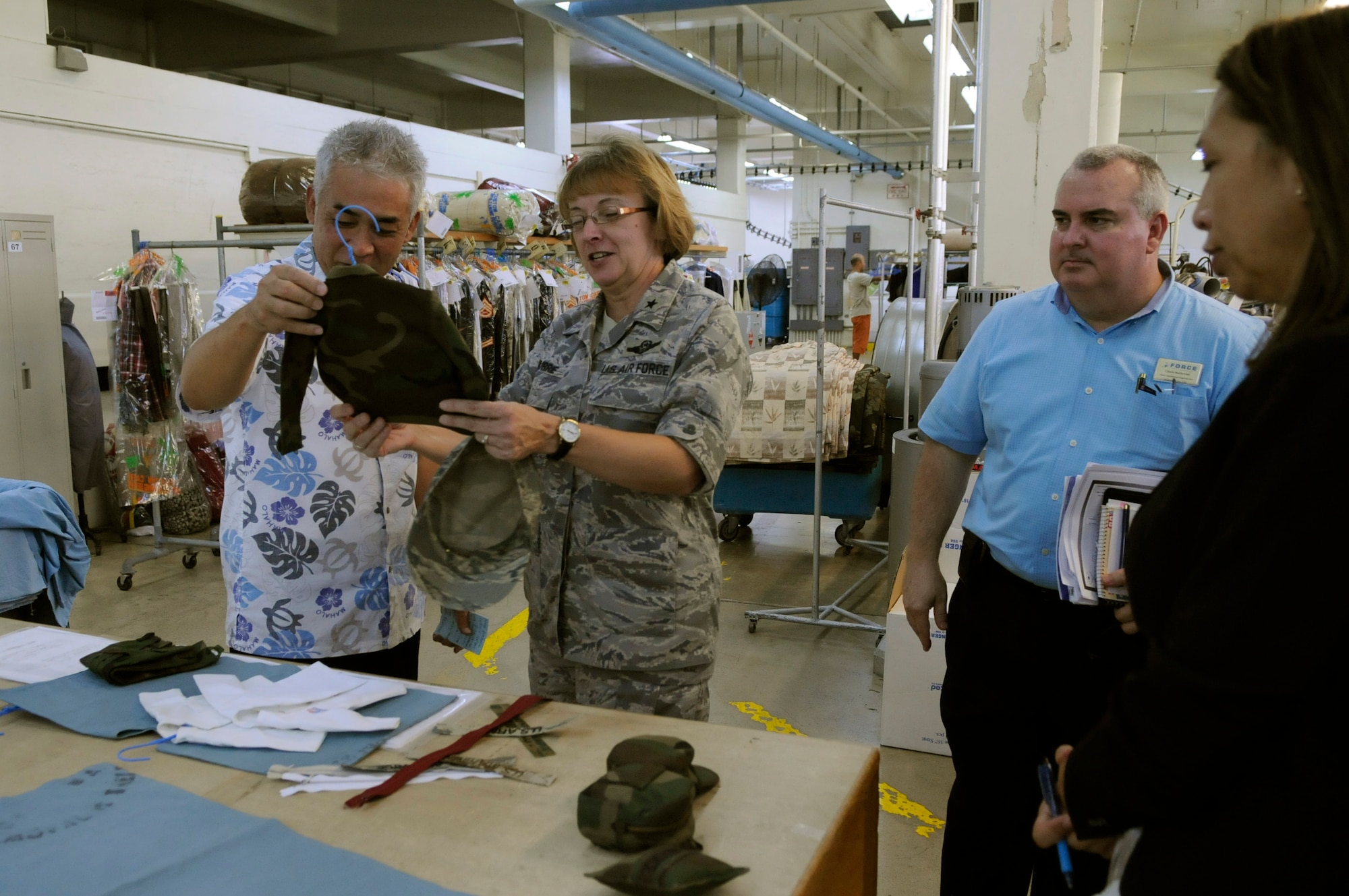 U.S. Air Force Brig. Gen. Eden Murrie, Air Force Services director, admires the craftsmanship of a miniature Air Force uniform made at the 18th Force Support Squadron Laundry Facility during a tour of the 18th FSS facilities on Camp Kinser, Japan, Aug. 17, 2012. The 18th FSS is responsible for the largest laundry and dry cleaning facility world-wide. (U.S. Air Force photo/ Airman 1st Class Tara A. Williamson)