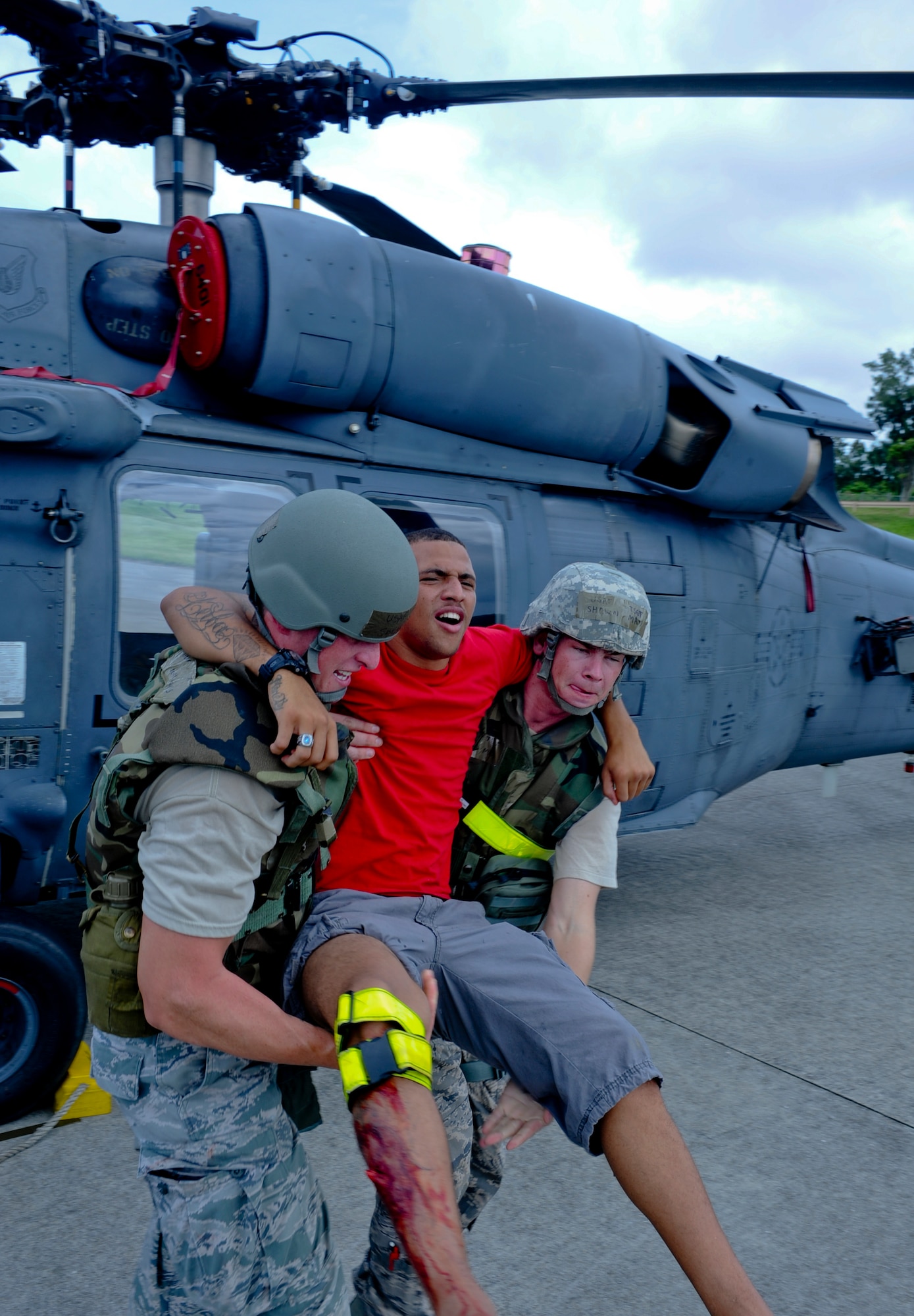 U.S. Air Force Airman Michael Leiba, 18th Security Forces Squadron response force member, gets carried by members from the 33rd Rescue Squadron during local operational readiness exercise Beverly High 12-5 on Kadena Air Base, Japan, Aug. 21, 2012. This week-long local operational readiness exercise tests the Airmen on their ability to survive and operate in a multitude of scenarios in order to prepare them for real world contingencies. (U.S. Air Force photo/Airman 1st Class Justin Veazie)