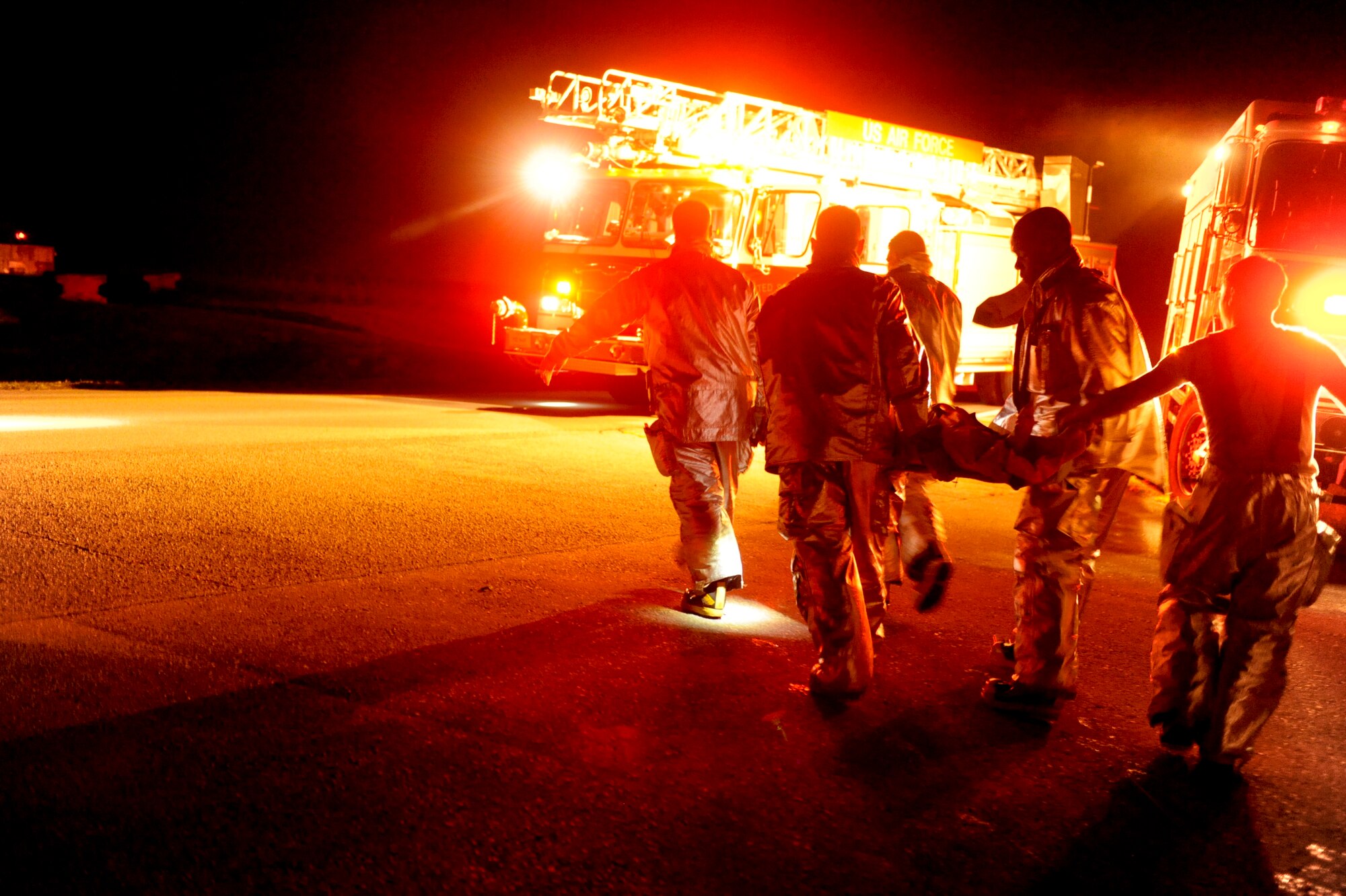 Firefighters from the 18th Civil Engineer Squadron carry simulated victim, U.S. Air Force Airman 1st Class Marcanthony Black, 18th Logistics Readiness Squadron vehicle operation dispatcher, to their vehicle during a training inject for local operational readiness exercise Beverly High 12-5 on Kadena Air Base, Japan, Aug. 21, 2012. LOREs allow for Airmen to train in a controlled environment and prepare themselves for future real world contingencies. (U.S. Air Force photo/Airman 1st Class Brooke P. Beers)